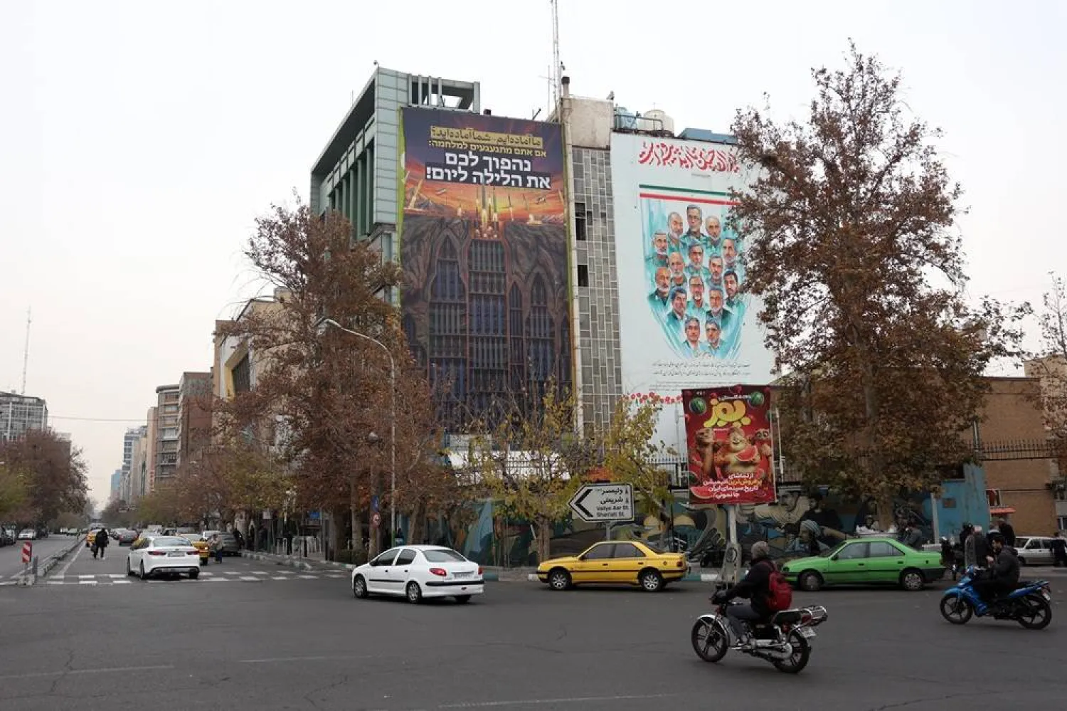 Iranians drive past an anti-Israeli billboard carrying a sentence in Persian reading 'We are ready, are you ready?' hanging at Palestine Square in Tehran, Iran, 24 December 2025. (EPA)