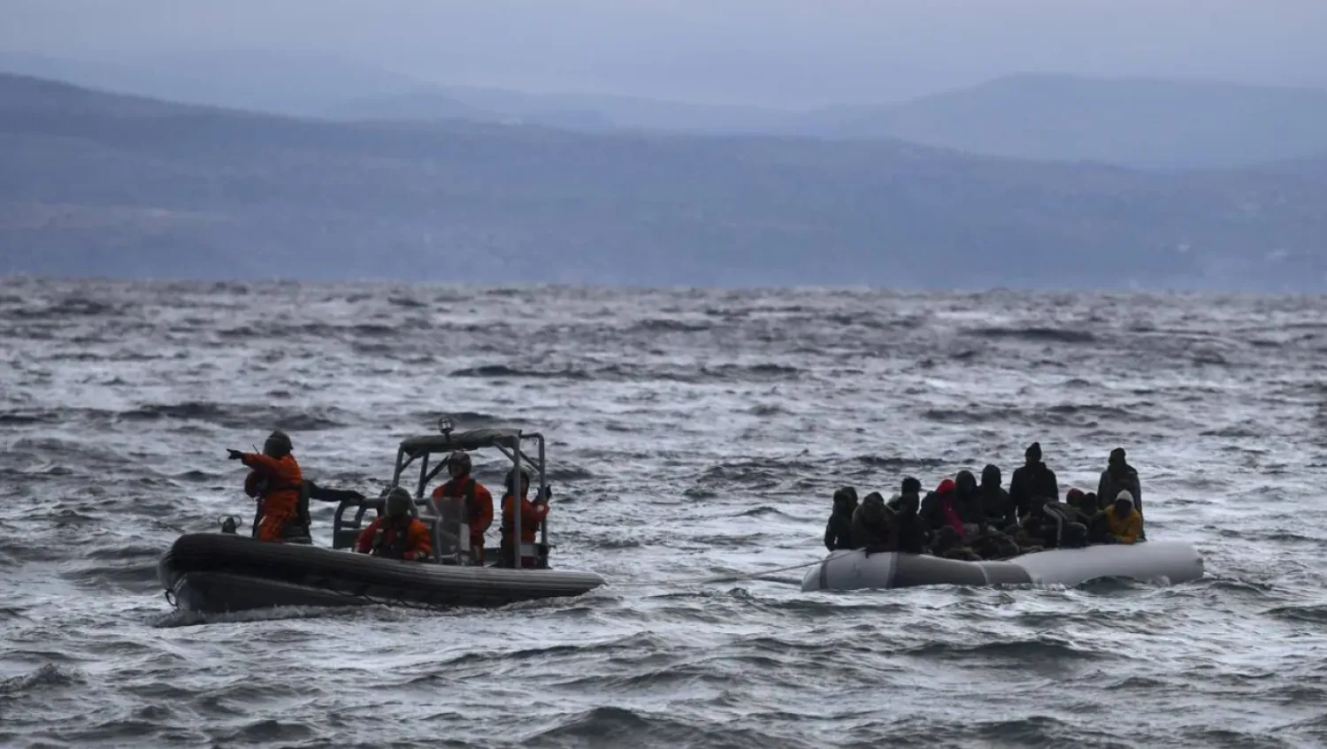 A dinghy transporting dozens of refugees and migrants is pulled towards Greece's Lesbos island after being rescued by a war ship during their sea crossing between Türkiye and Greece on February 29, 2020. Aris Messinis, AFP/File picture
