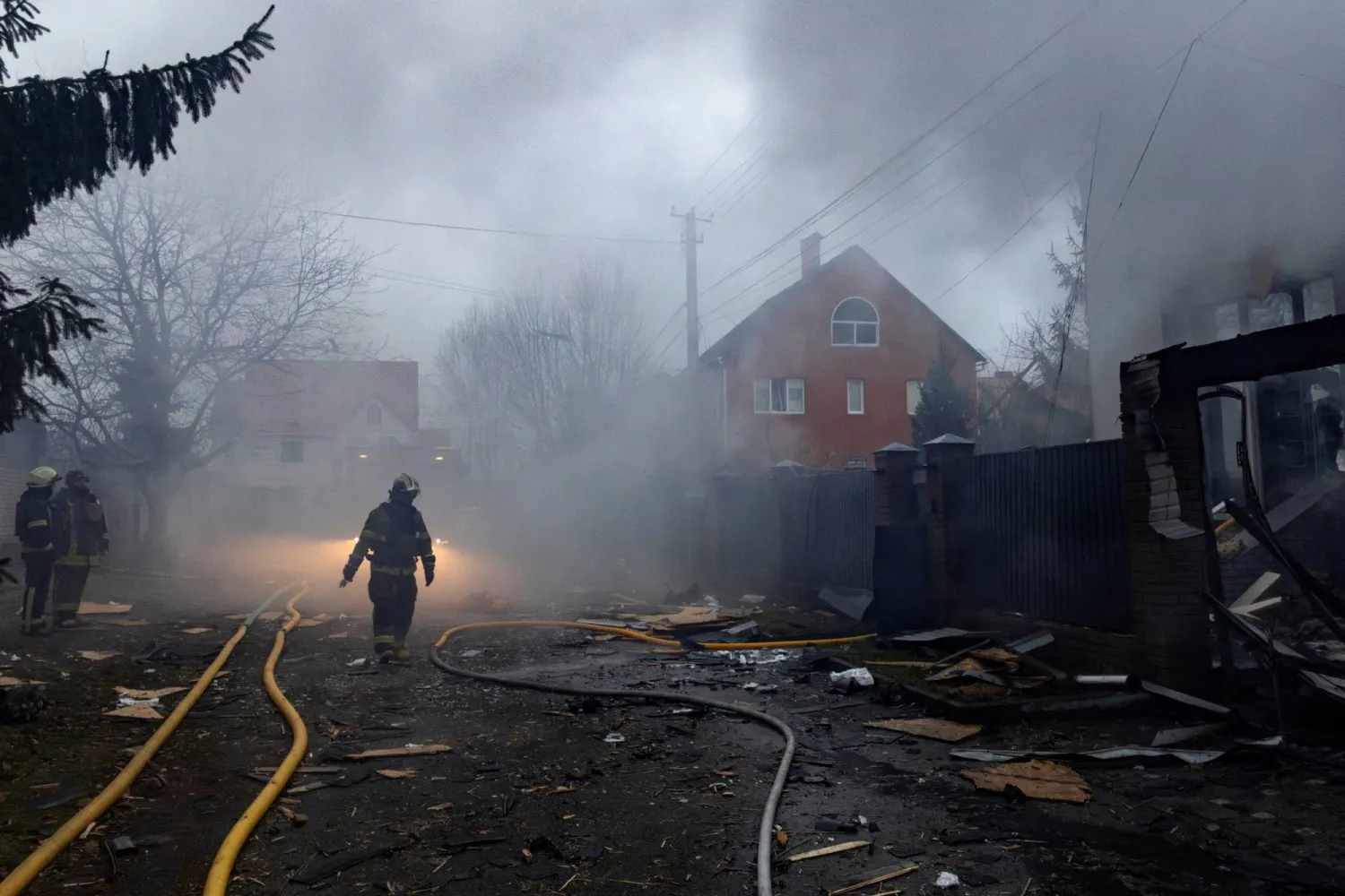 Firefighters work at the site of a private home that went up in flames after it was hit by a Russian drone during a night of attacks on Kyiv, amid Russia's attack on Ukraine, November 29, 2025. REUTERS/Thomas Peter