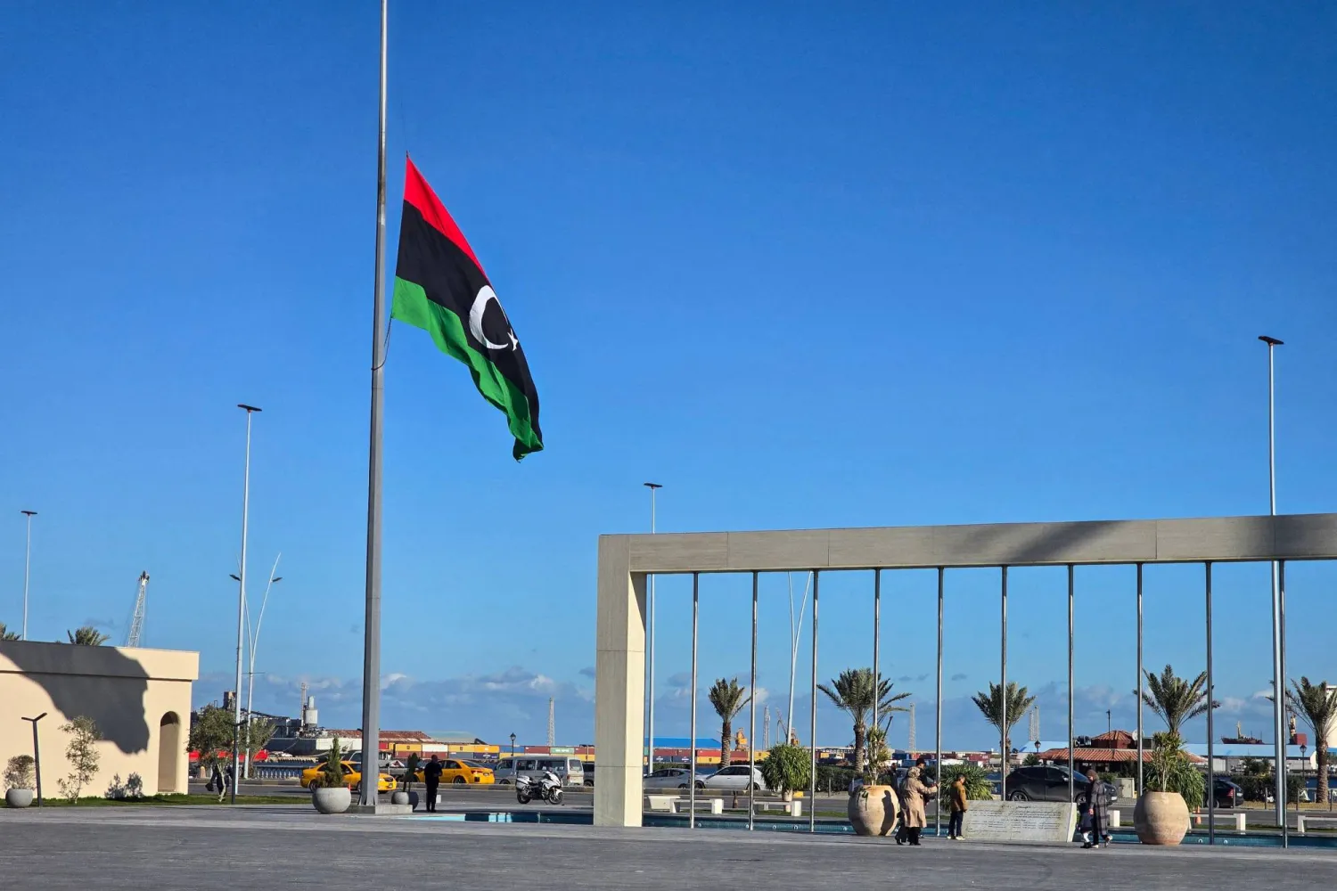 The Libyan national flag flies at half-mast in Tripoli on December 24, 2025, after the head of Libya's armed forces and his four aides died in a plane crash in Türkiye. (AFP)