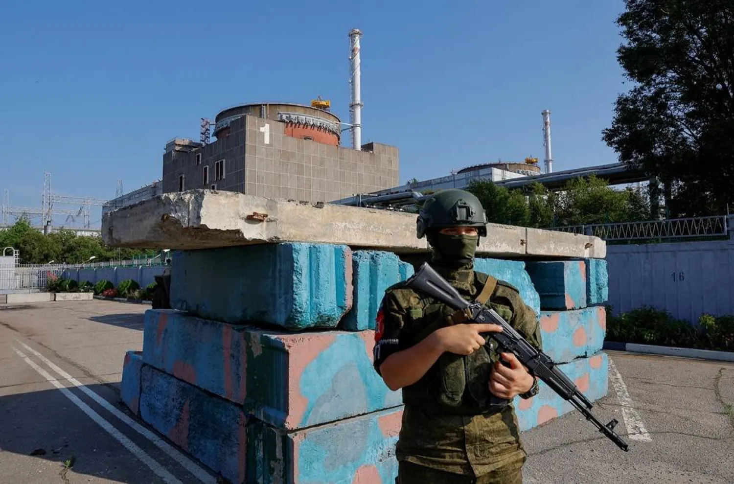A Russian service member stands guard at a checkpoint near the Zaporizhzhia Nuclear Power Plant before the arrival of the International Atomic Energy Agency (IAEA) expert mission in the course of Russia-Ukraine conflict outside Enerhodar in the Zaporizhzhia region, Russian-controlled Ukraine, June 15, 2023. (Reuters)