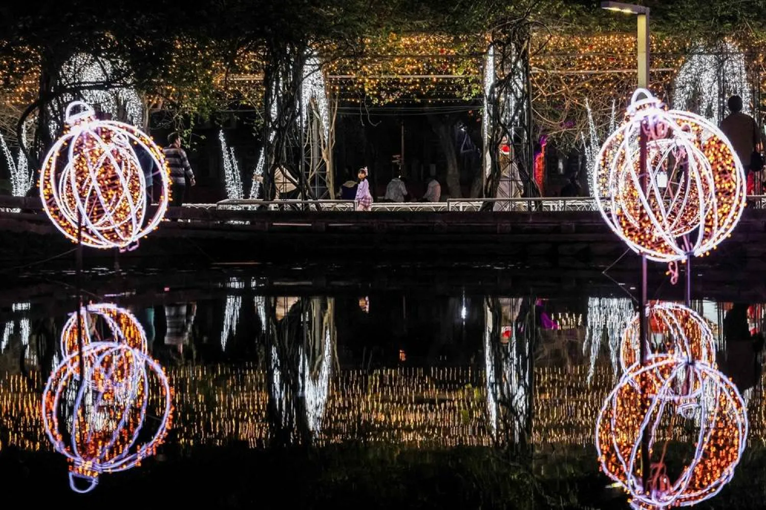  People visit a street decorated with lights ahead of the Christmas festival in Pingtung, southern Taiwan, on December 22, 2025. (AFP) 