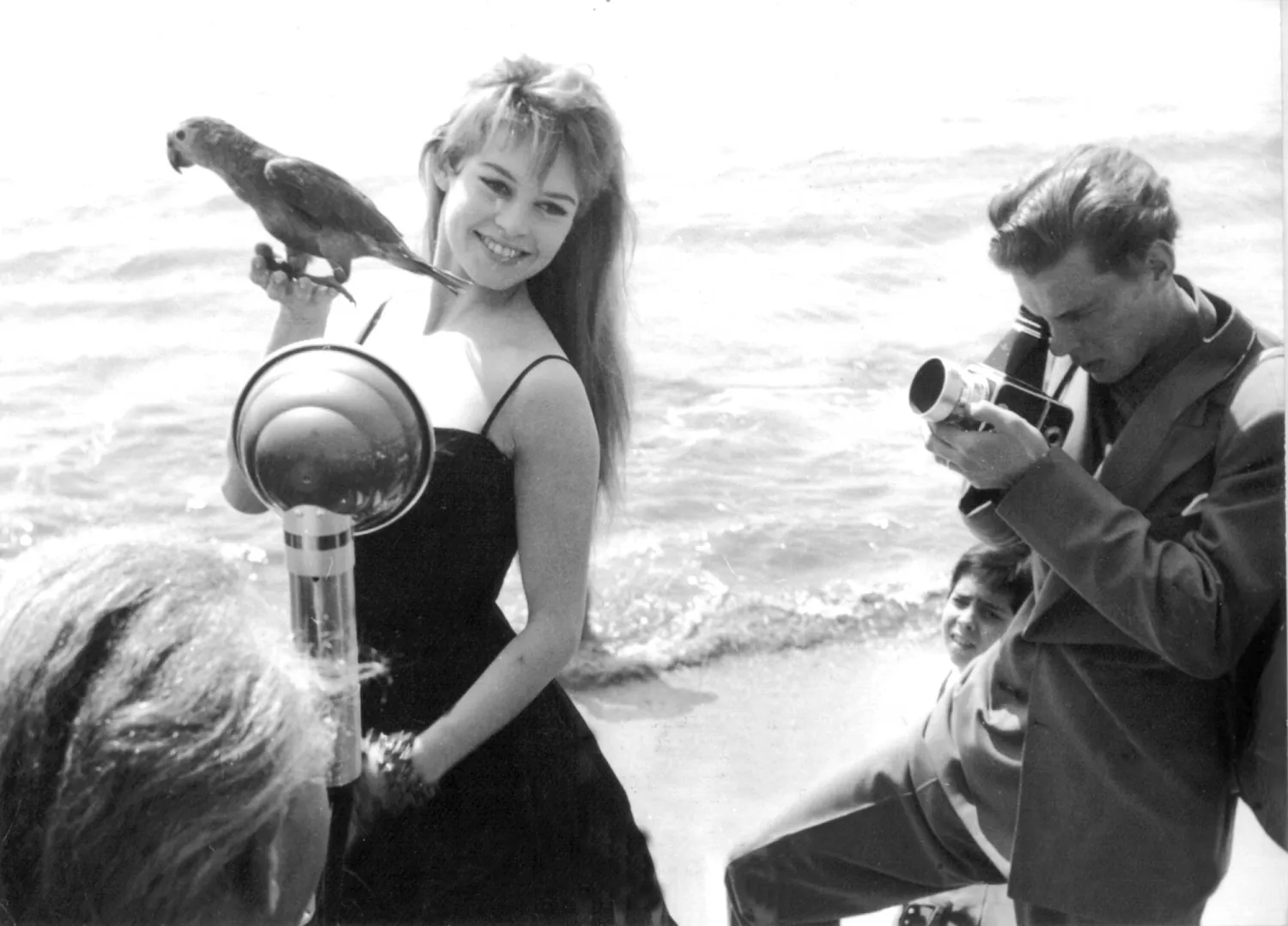 FILED - 01 April 1956, France, Cannes: Then French actress and singer Brigitte Bardot is photographed with a parrot in her hand on the beach during the Cannes Film Festival. Photo: -/AFP Intercontinentale/dpa