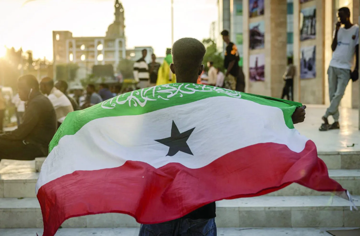 Man holding the Somaliland flag in front of the Hargeisa War memorial (AFP).