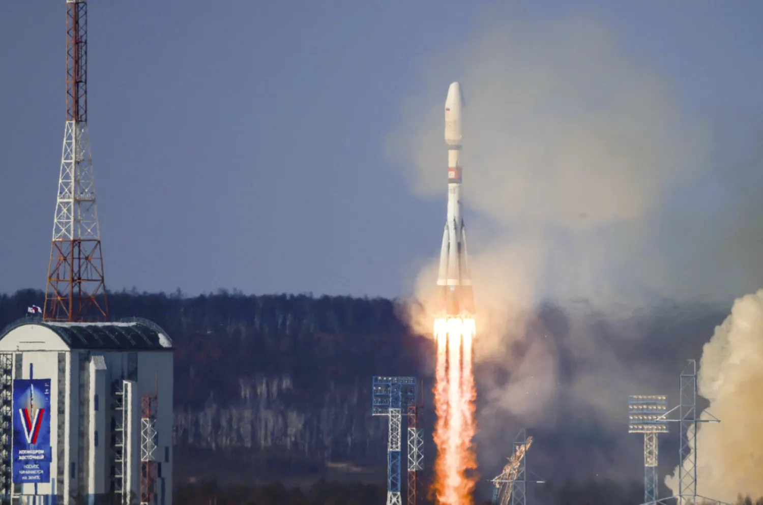 In this photo released by Roscosmos space corporation on Thursday, Feb. 29, 2024, the Soyuz-2.1b rocket blasts off at the Vostochny cosmodrome outside the city of Tsiolkovsky, about 200 kilometers (125 miles) from the city of Blagoveshchensk in the far eastern Amur region, Russia. A Russian Soyuz rocket successfully put an Iranian satellite into orbit along with 18 Russian satellites on Thursday. (Roscosmos space corporation via AP)