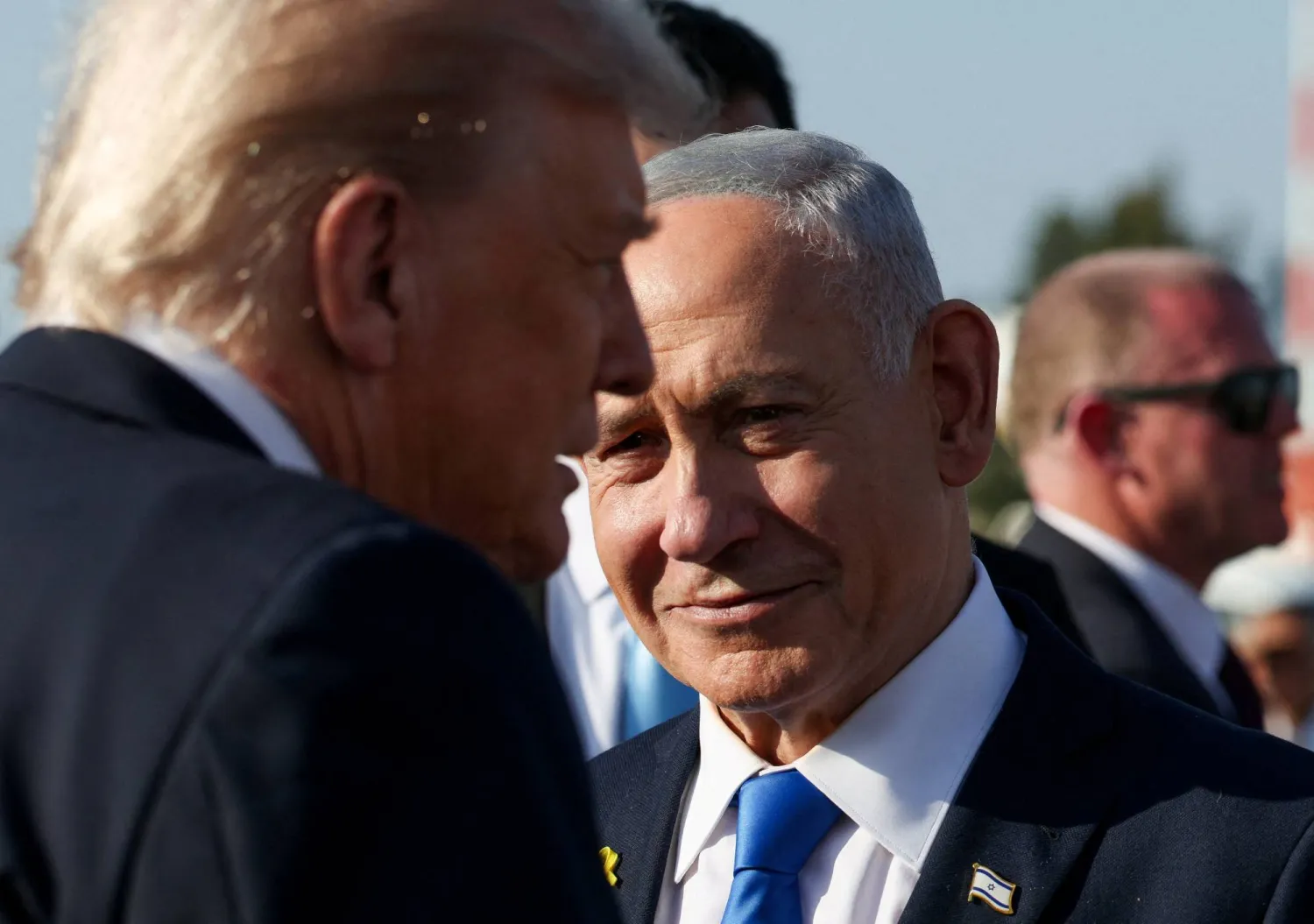 Israeli Prime Minister Benjamin Netanyahu looks on next to US President Donald Trump as Trump leaves Israel en route to Sharm El-Sheikh, Egypt, to attend a world leaders' summit on ending the Gaza war, amid a US-brokered prisoner-hostage swap and ceasefire deal between Israel and Hamas, at Ben Gurion International Airport in Lod, Israel, October 13, 2025. (Reuters)