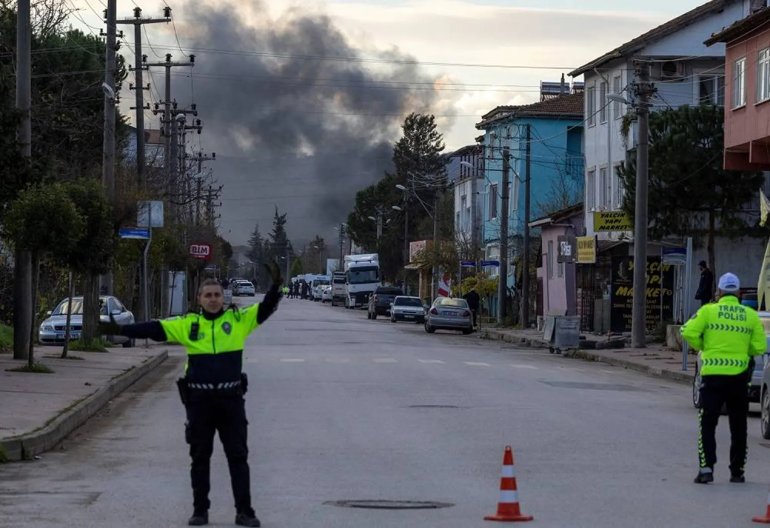 Smoke rises in the background as police block a road leading to a site where Turkish police launched an operation on a house believed to contain suspected ISIS militants, and where, according to state media, seven officers were wounded in a clash, in Yalova province, Türkiye, December 29, 2025. (Reuters)