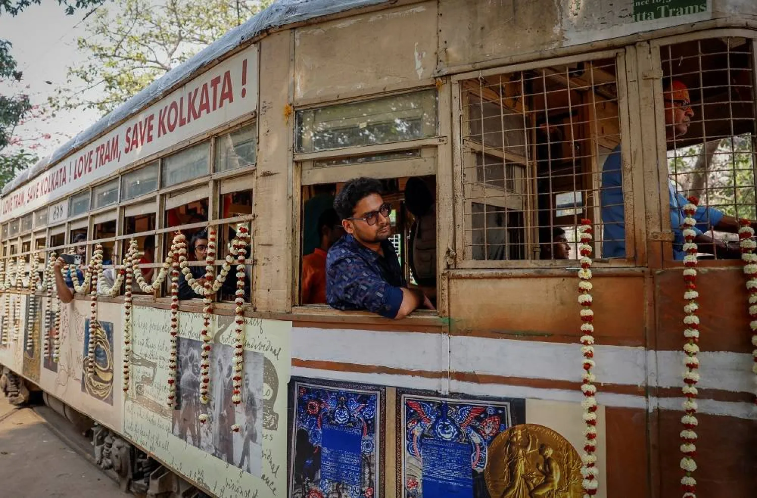 Passengers sit inside a decorated tram during the 152nd anniversary celebrations of trams in Kolkata, India, February 24, 2025. (Reuters)