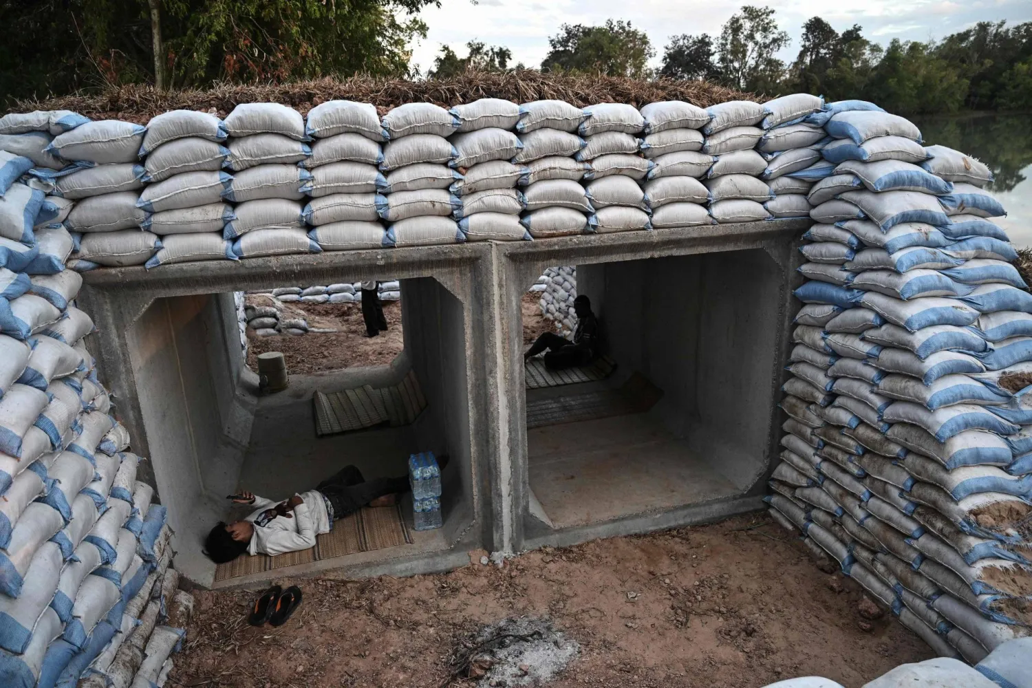 Displaced residents rest in a bunker in Thailand's Surin province on December 11, 2025, amid clashes along the Thai-Cambodia border. (AFP)
