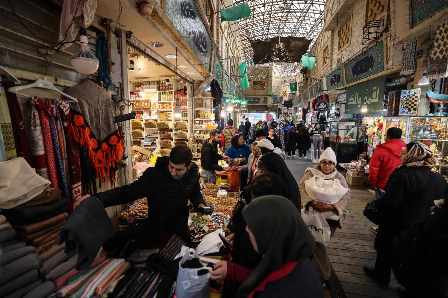  People shop at Tajrish Bazaar in the Iranian capital Tehran on December 29, 2025. (AFP)