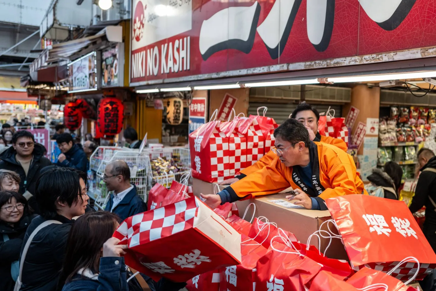 متسوقون في سوق شعبية بالعاصمة اليابانية طوكيو (أ.ف.ب)