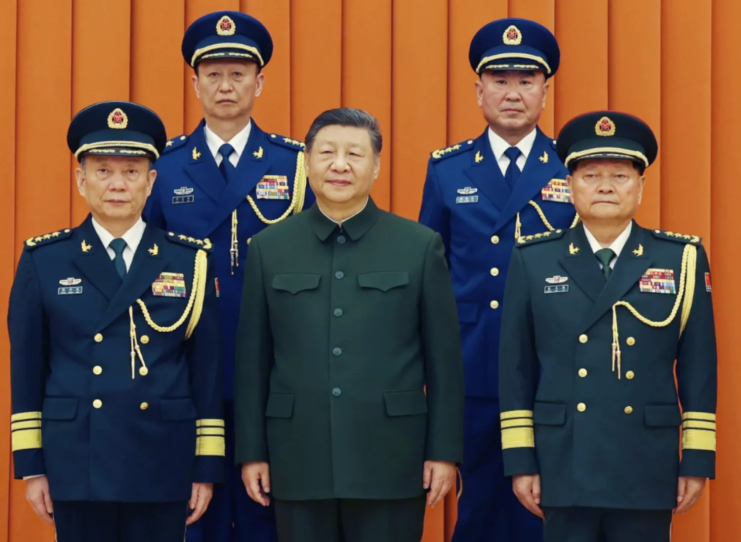  In this photo released by Xinhua News Agency, Chinese President Xi Jinping, also chairman of the Central Military Commission (CMC), front row second from left, poses with other military officers after promoting to generals, back row, from left, Yang Zhibin of the Eastern Theater Command and Han Shengyan commander of Central Theater Command in Beijing on Monday, Dec. 22, 2025. (Li Gang/Xinhua via AP)

