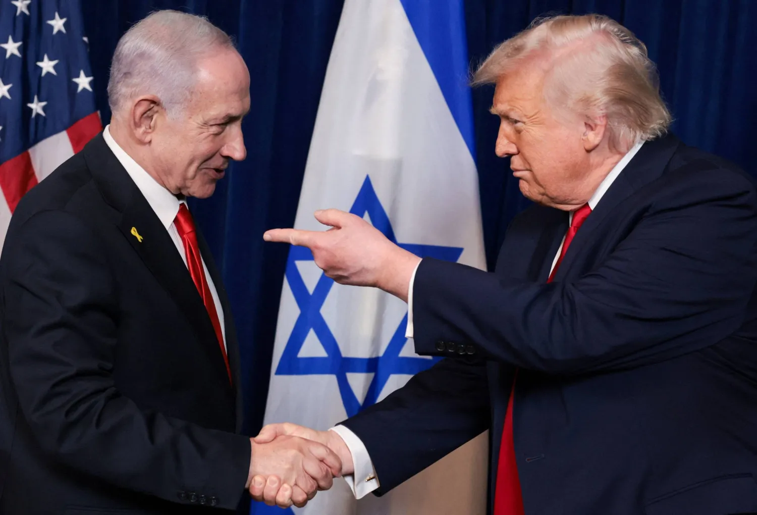 US President Donald Trump points his finger towards Israeli Prime Minister Benjamin Netanyahu as they shake hands during a press conference after meeting at Trump’s Mar-a-Lago club in Palm Beach, Florida, US, December 29, 2025. (Reuters)