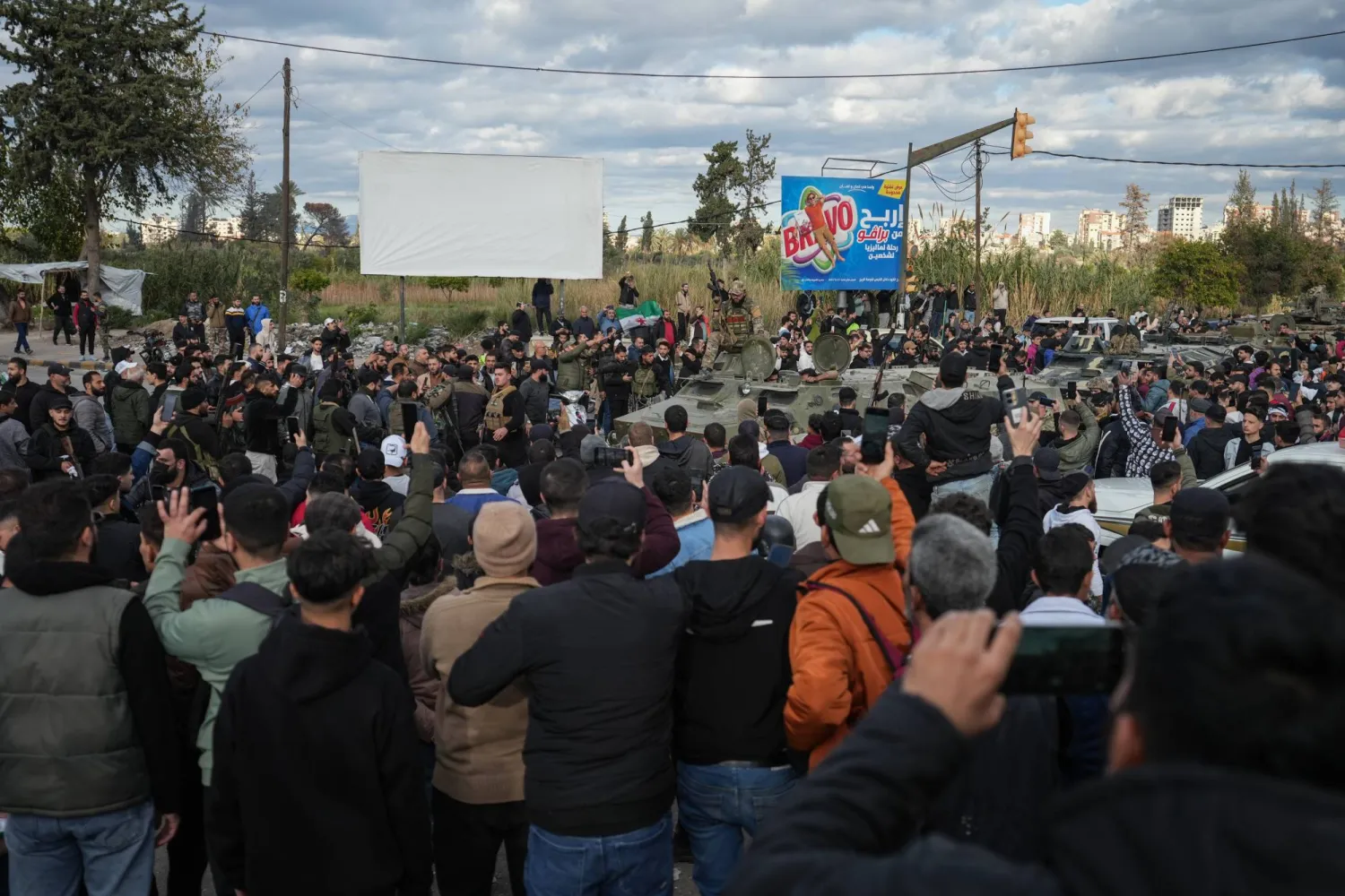 People watch as Syrian Security forces are deployed after clashes erupted during a protest in the city of Latakia, Syria, 28 December 2025. EPA/AHMAD FALLAHA 