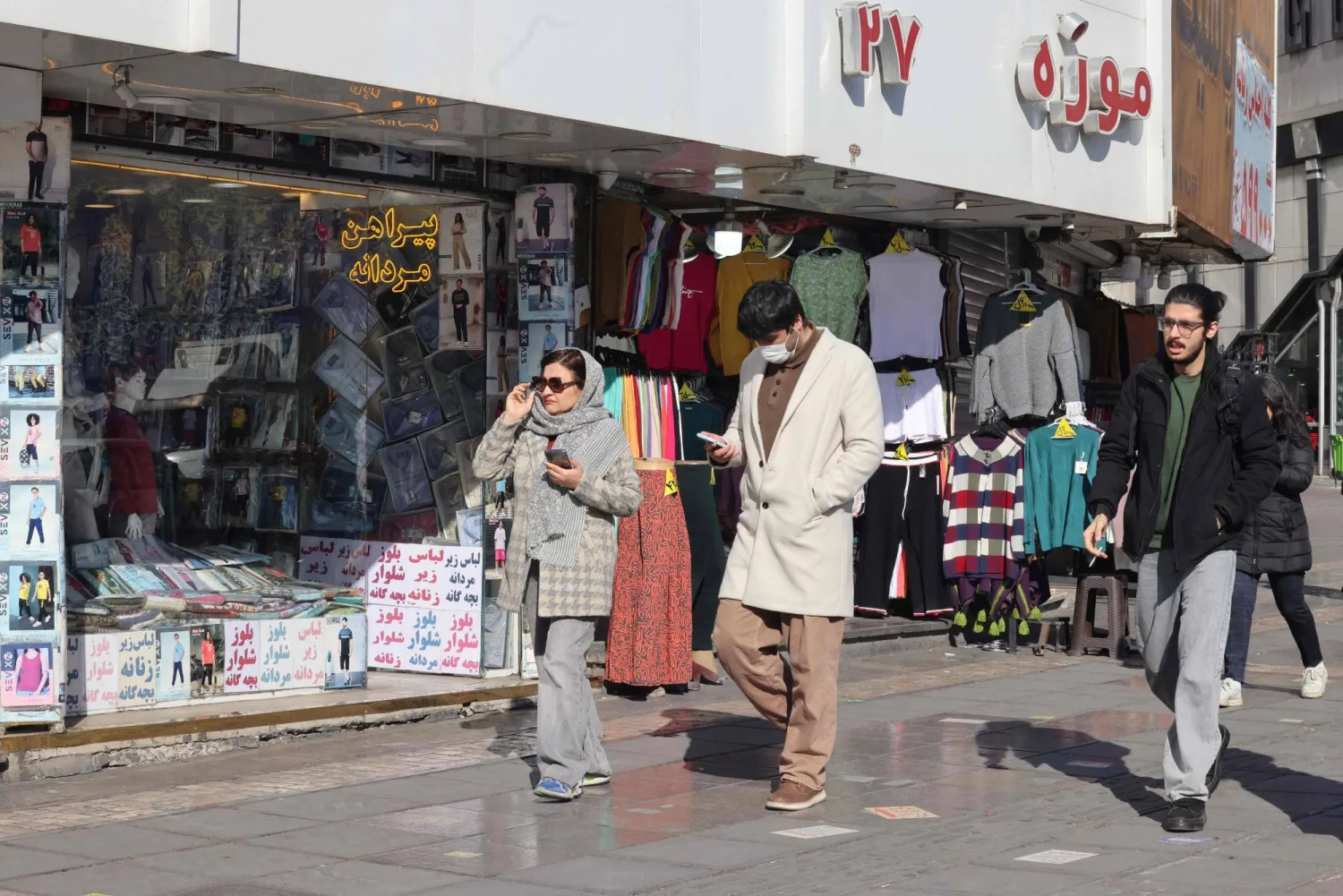 Iranians walks past shops in Vali-Asr Square in the Iranian capital Tehran, on the last day of the year on December 31, 2025. (AFP)