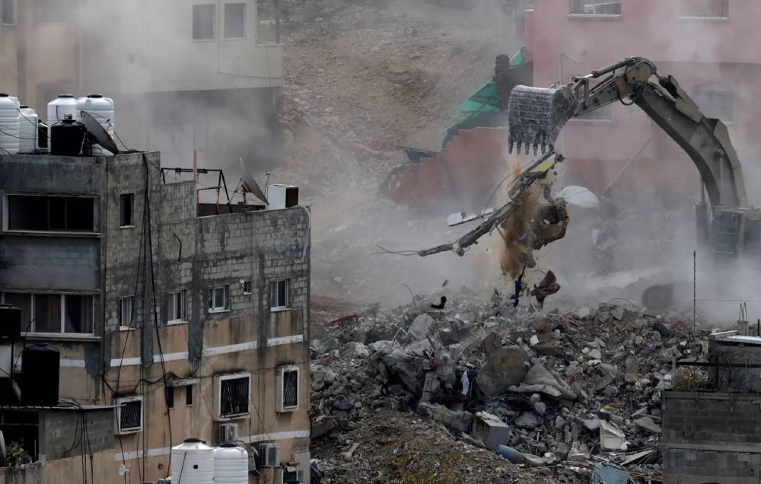 An Israeli army excavator demolishes buildings during a military operation in Nur Shams refugee camp, near the West Bank city of Tulkarem, 31 December 2025. (EPA)