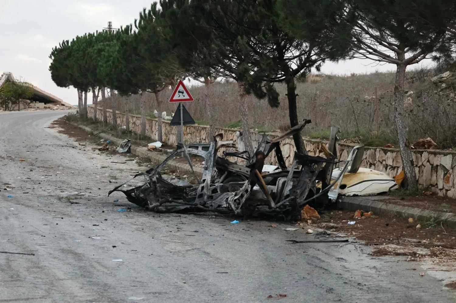 A photograph shows the wreckage of a vehicle targeted by an Israeli airstrike on the road linking the southern Lebanese border village of Odeisseh to Markaba, on December 16, 2025. (AFP)