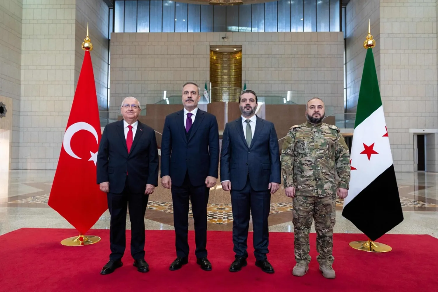 This handout photograph released by the Turkish Foreign Ministry press service shows Turkish Foreign Minister Hakan Fidan (2nd-L) and Turkish Minister of National Defense Yasar Guler (L) meeting with Syria's Foreign Minister Asaad al-Shaibani (2nd-R) and Syria's Defense Minister Murhaf Abu Qasra (R) in Damascus on December 22, 2025. (Turkish Foreign Ministry Press Service / AFP) 