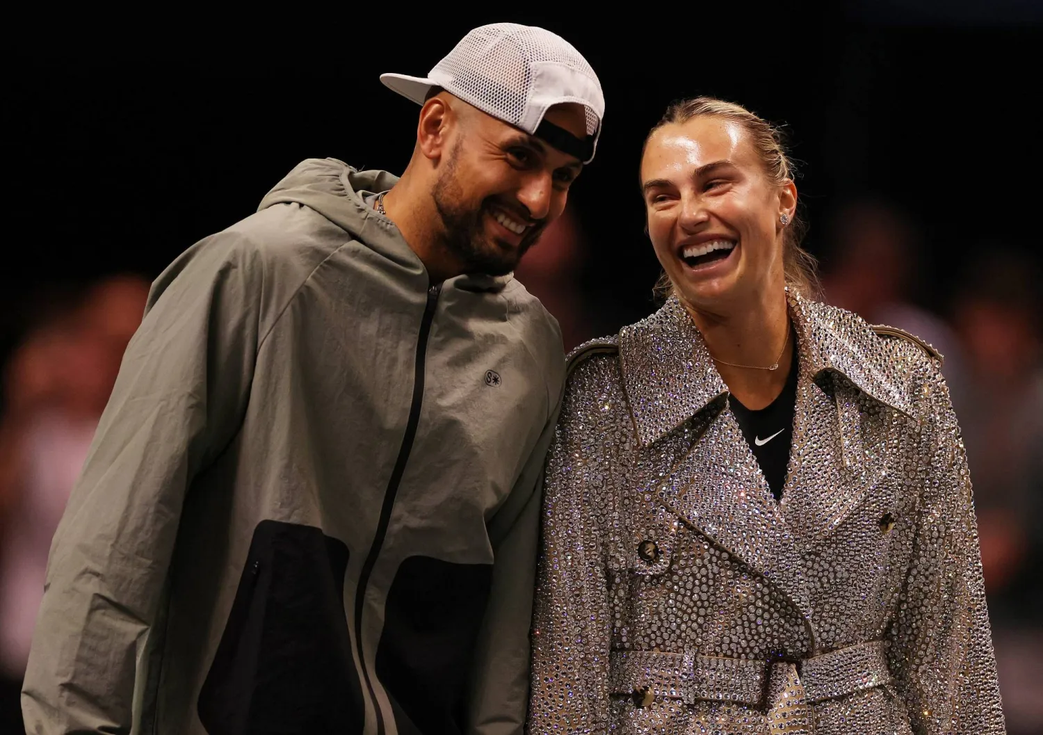 Aryna Sabalenka and Nick Kyrgios laugh ahead of their Battle of the Sexes tennis match in Dubai, United Arab Emirates, Sunday Dec. 28, 2025. (Amr Alfiky/Pool Photo via AP)