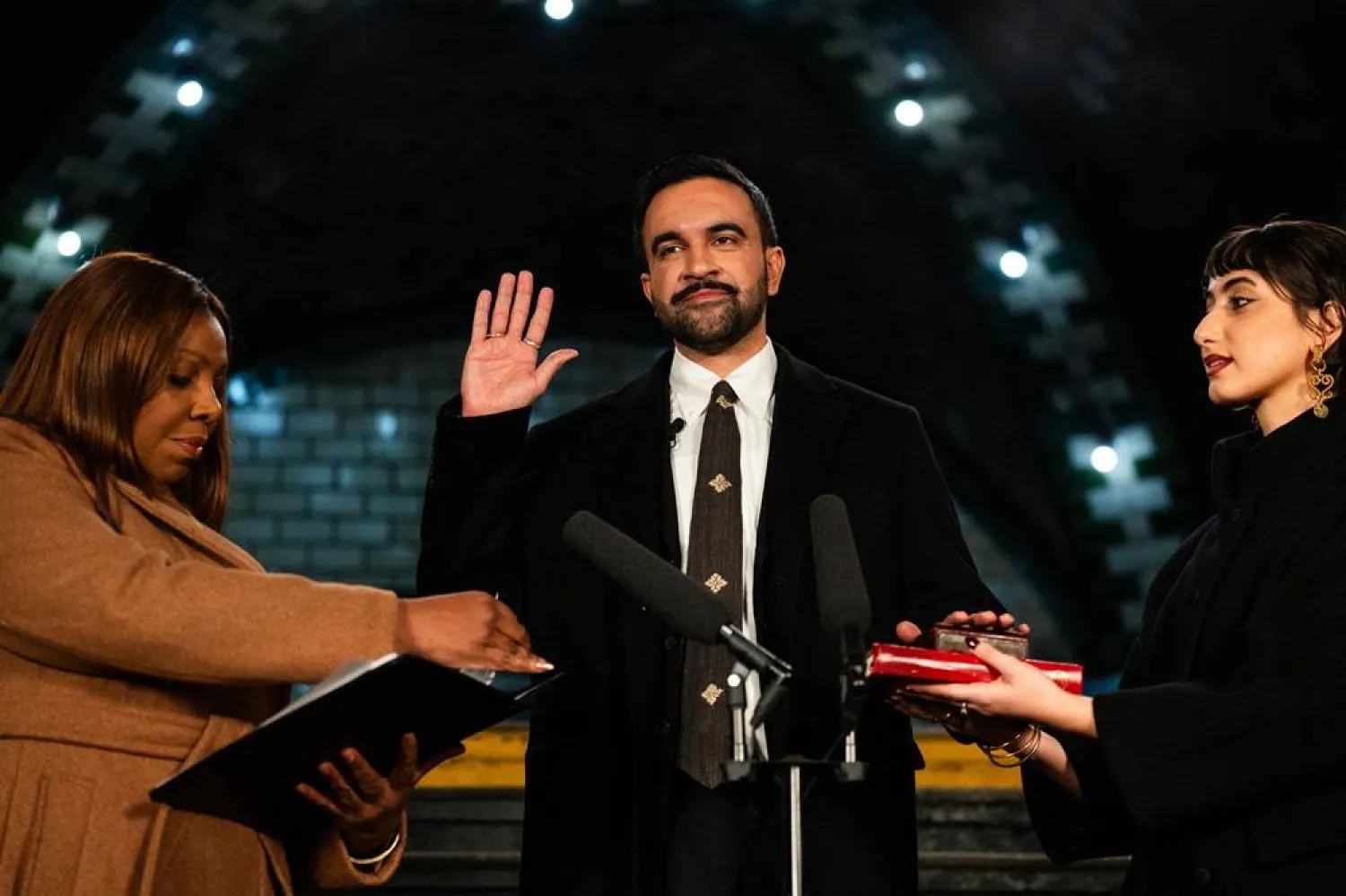 New York mayor-elect Zohran Mamdani (C) places his hand on a holy Quran as he is sworn in by New York Attorney General Letitia James (L) and his wife Rama Duwaji looks on in New York, on January 1, 2026. (AFP)