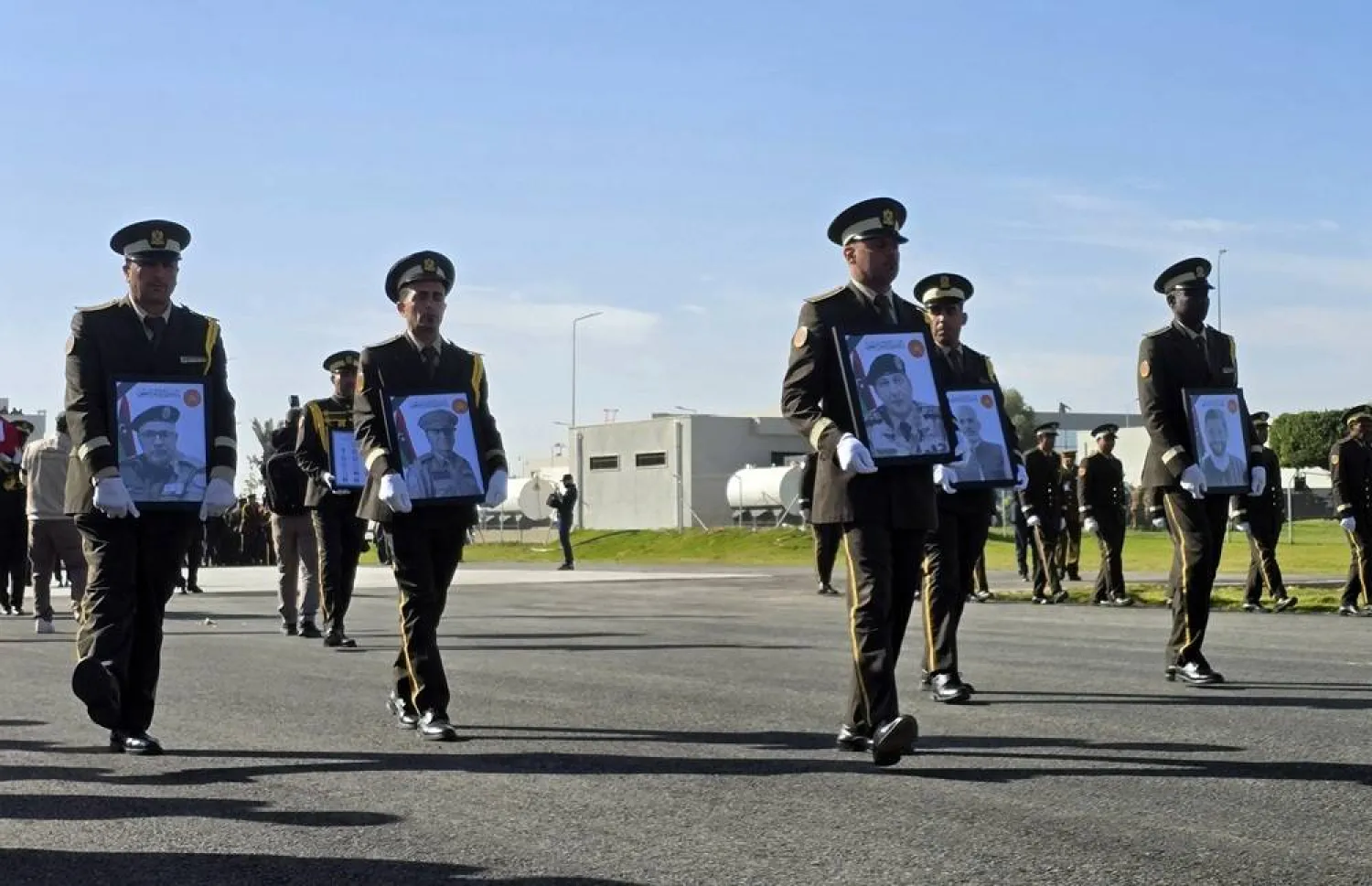 Military personnel carry portraits of the Libyan chief of staff, General Mohamed al-Haddad (2-R), and his four advisers, who were killed in a plane crash in Türkiye, during an official repatriation ceremony at the Ministry of Defense headquarters in Tripoli, Libya, 27 December 2025. (EPA) 