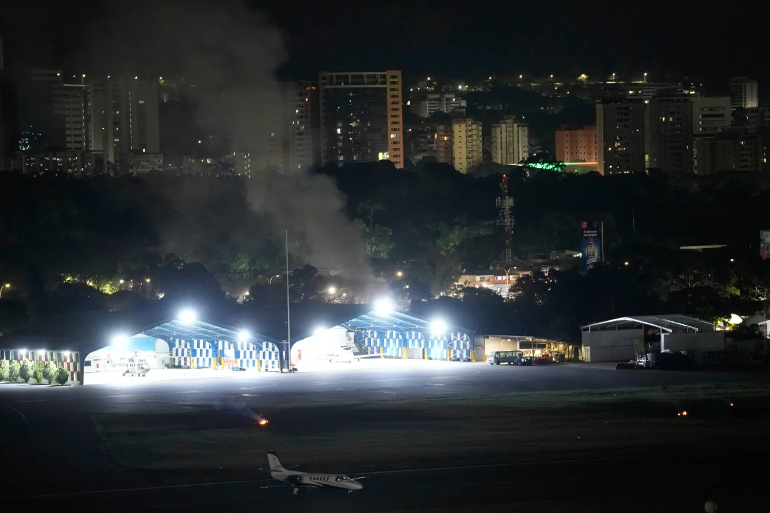 Smoke raises at La Carlota airport after explosions and low-flying aircraft were heard in Caracas, Venezuela, Saturday, Jan. 3, 2026. (AP Photo/Matias Delacroix)