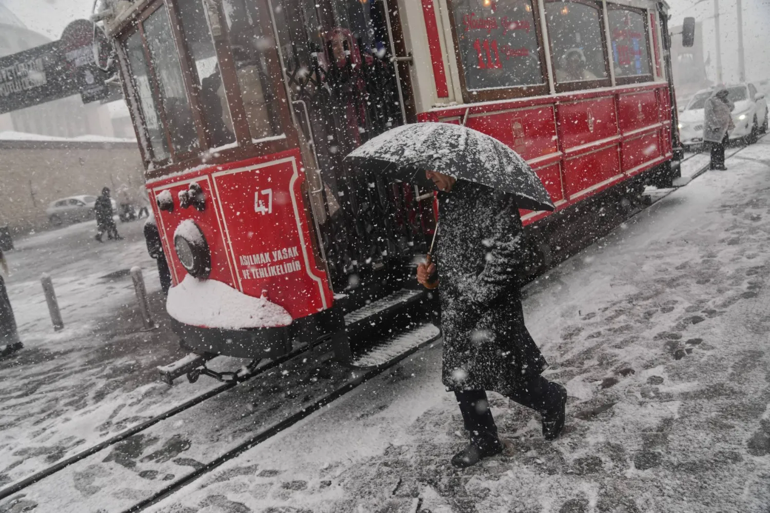 People walk along Taksim square during the first snowfall of the year, in Istanbul, Türkiye, Thursday, Jan. 1, 2026. (AP)