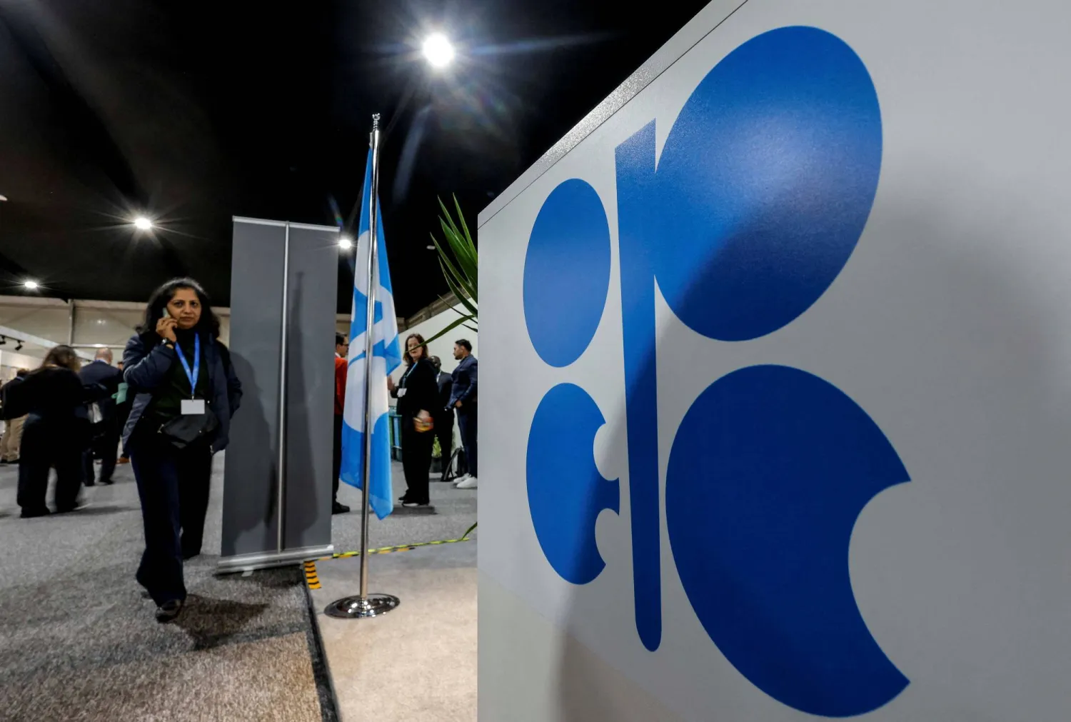 FILE PHOTO: A woman passes by a logo of Organization of the Petroleum Exporting Countries (OPEC) during the United Nations climate change conference COP29, in Baku, Azerbaijan November 13, 2024. REUTERS/Maxim Shemetov/File Photo