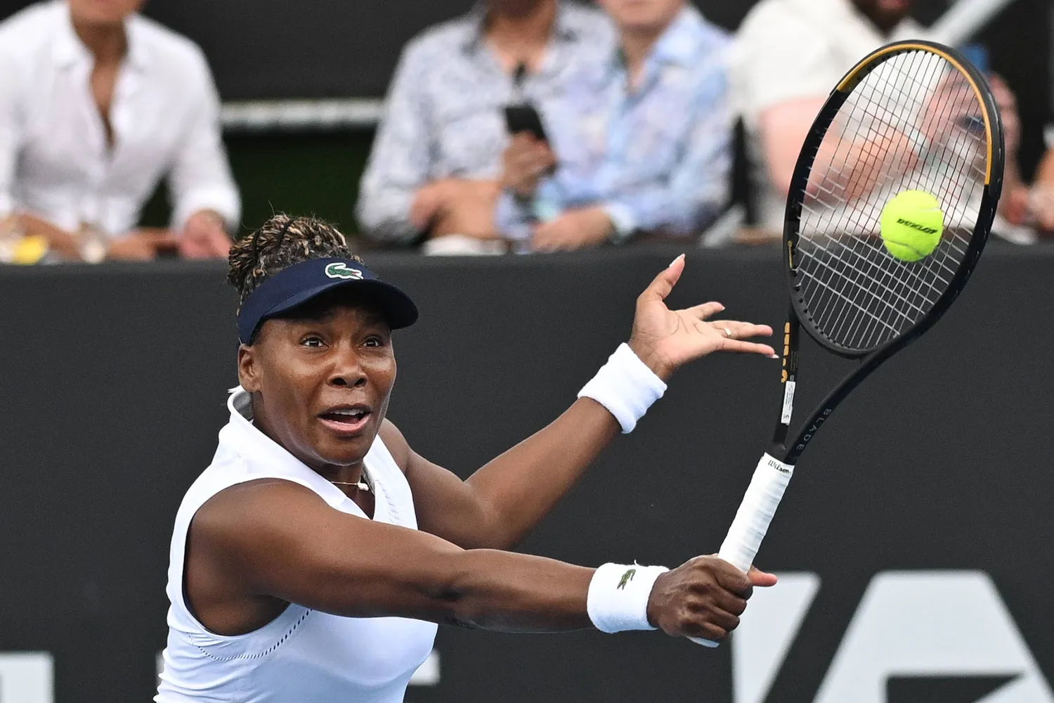 Venus Williams of the US hits a backhand to Magda Linette of Poland during her singles match of the ASB Classic Women's Tennis Tournament in Auckland, New Zealand, Tuesday Jan. 6, 2026. (Andrew Cornaga/Photosport via AP)