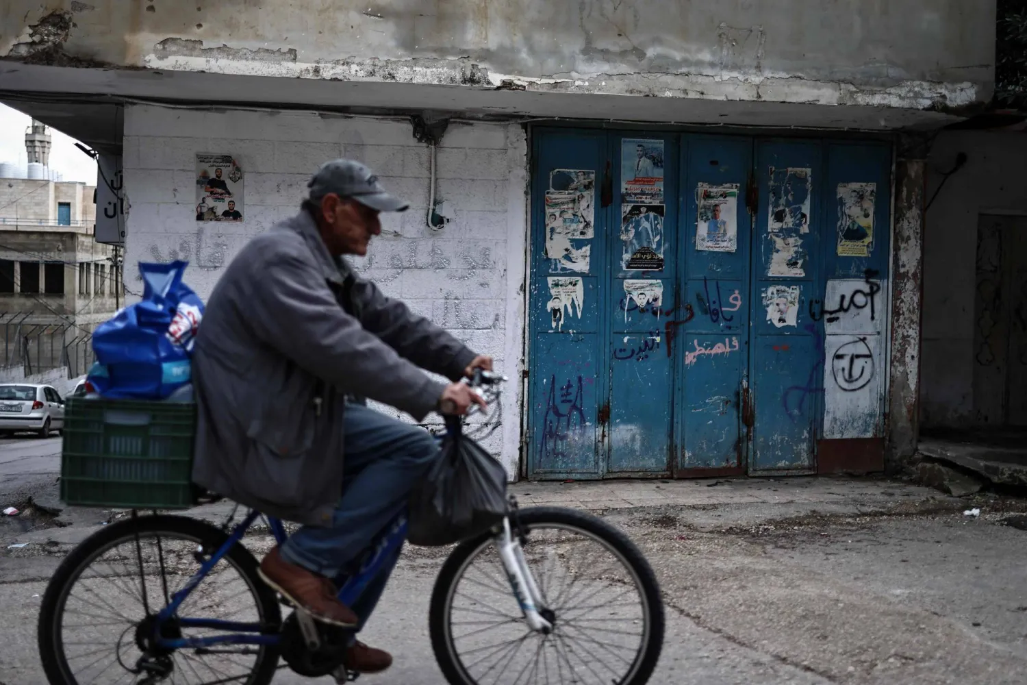  A man rides his bicycle at the Balata camp for Palestinian refugees, east of Nablus in the occupied West Bank on December 30, 2025. (AFP) 