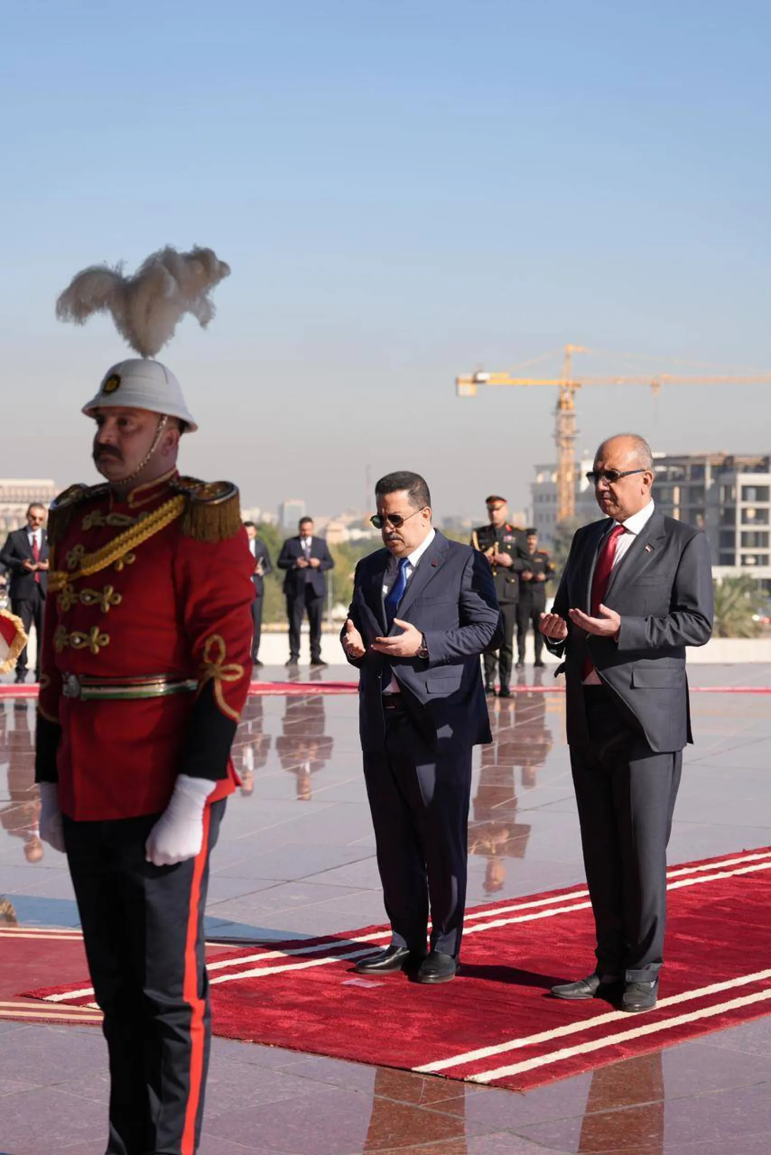 رئيس حكومة تصريف الأعمال محمد شياع السوداني ووزير الدفاع ثابت العباسي يقرآن الفاتحة أمام نصب الجندي المجهول في بغداد (المكتب الإعلامي لرئاسة الوزراء)