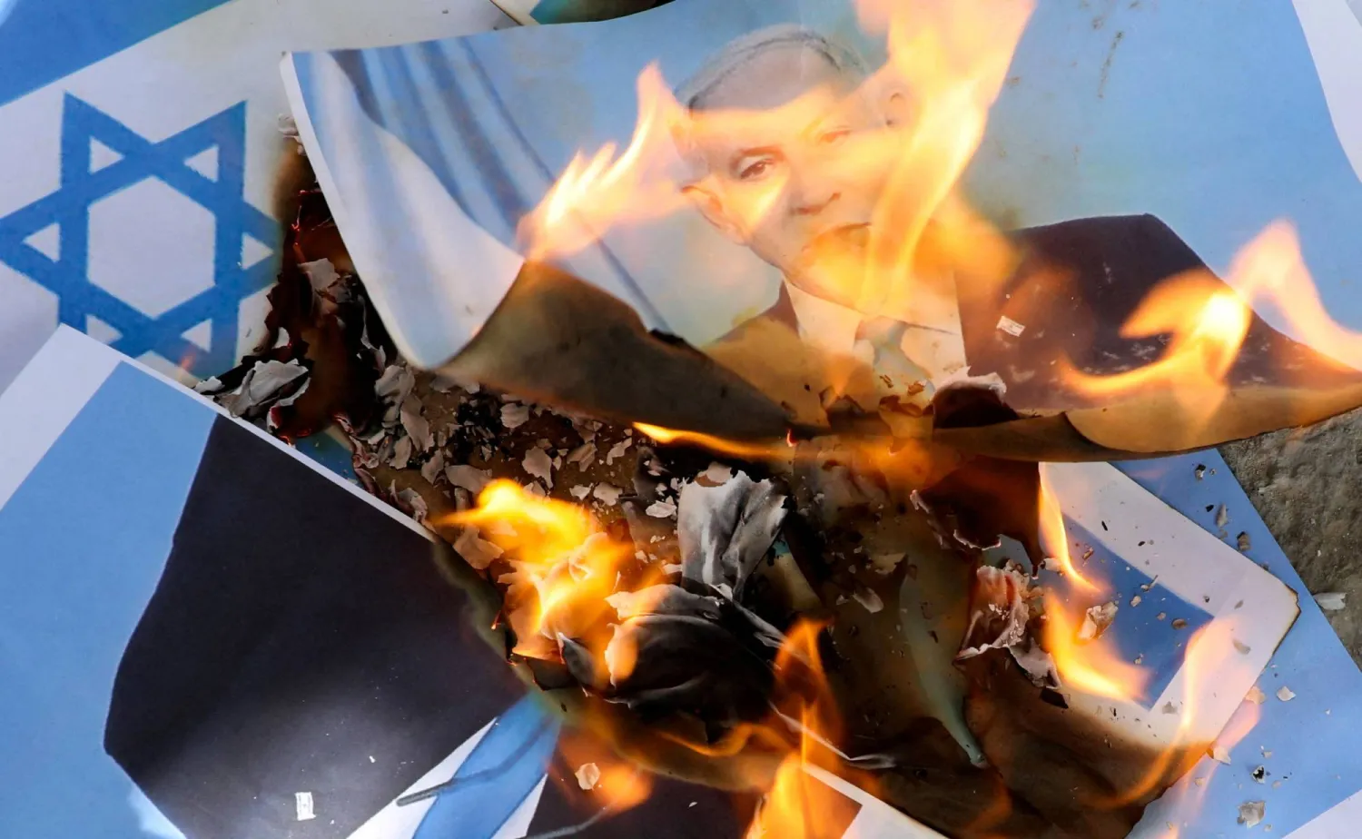 Somalis burn the Israel flag and an image depicting Israeli Prime Minister Benjamin Netanyahu during a demonstration, after Israel became the first country to formally recognize the self-declared Republic of Somaliland, at the Mogadishu Stadium in Warta Nabada district of Mogadishu, Somalia December 30, 2025. (Reuters)