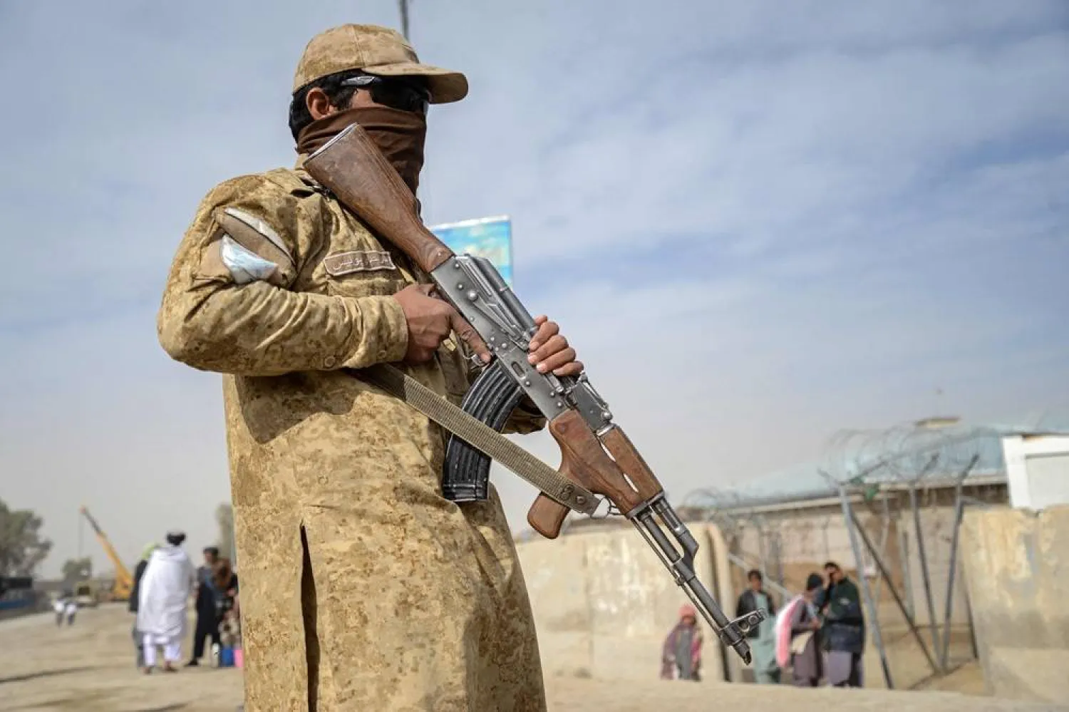 This photograph taken on December 29, 2025 shows a Taliban security personnel standing guard near the zero-point border crossing between Afghanistan and Pakistan at the Spin Boldak district of Kandahar province. (AFP) 