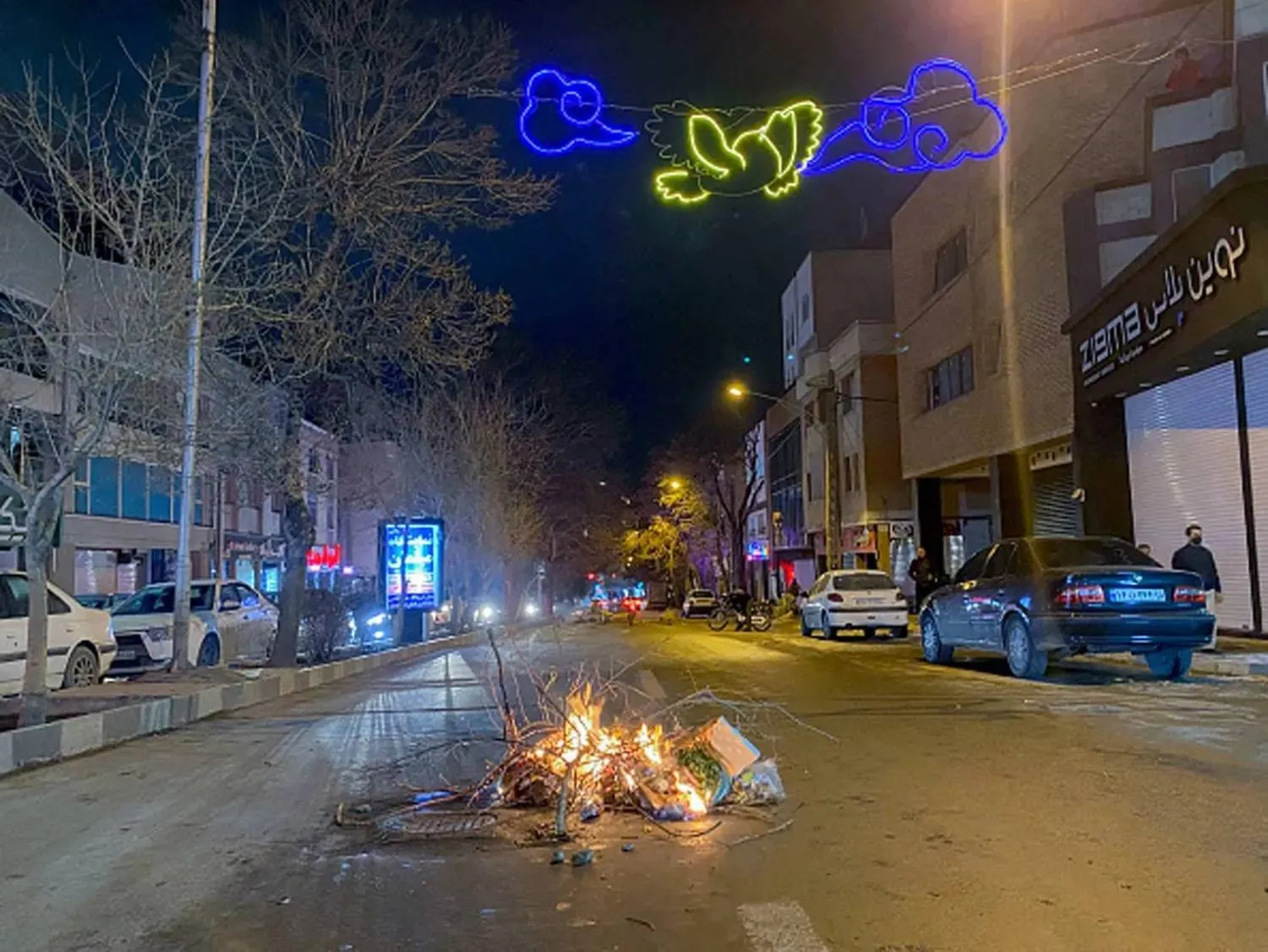 Burning debris lies in the middle of a street during protests in Hamedan, western Iran, Jan. 1, 2026. (AFP/Getty Images) 