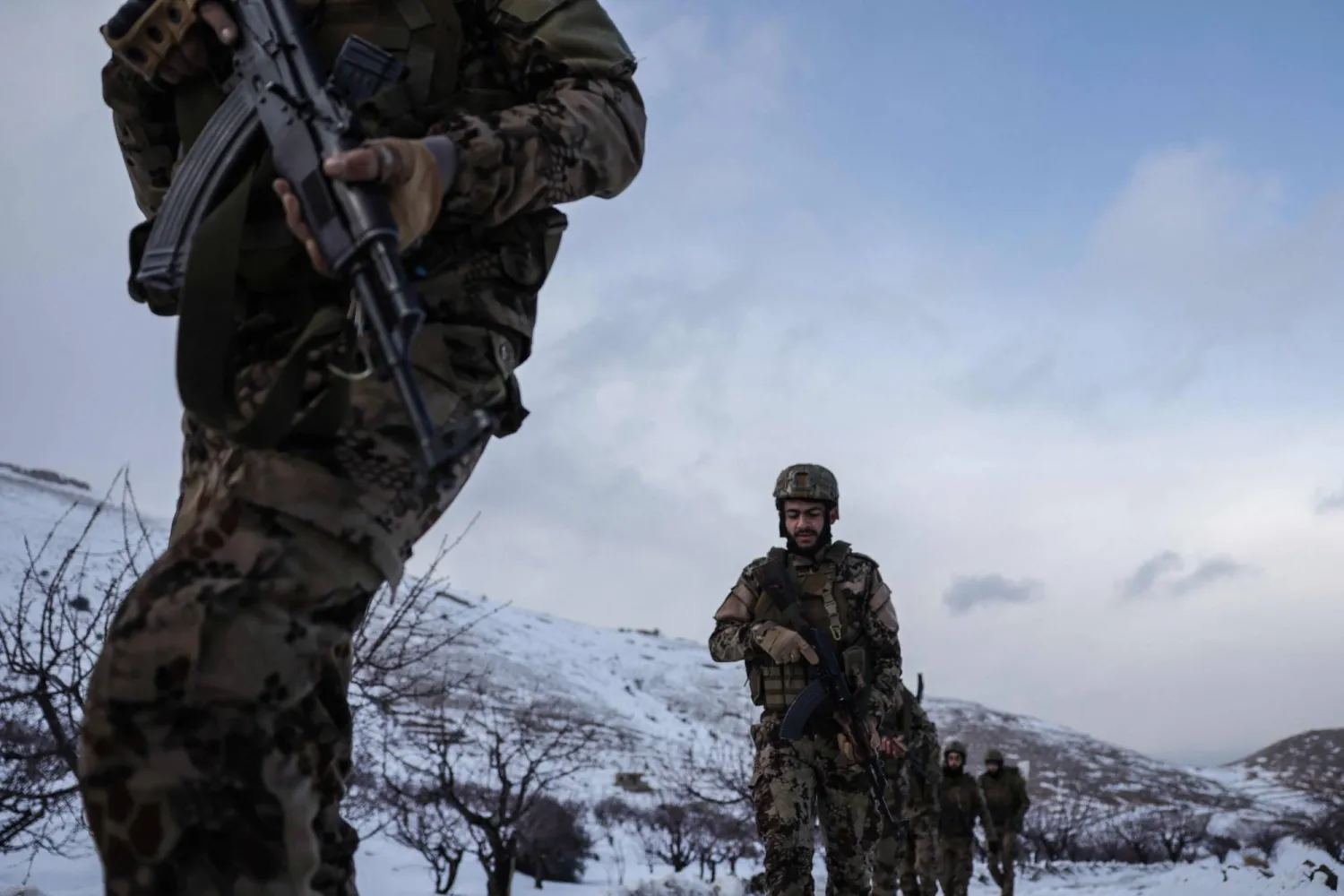 Syrian soldiers make their way through the snow in the country's mountainous Qalamoun region, near the border with Lebanon, during a patrol to secure the frontier and prevent smuggling operations on January 1, 2026. (AFP)