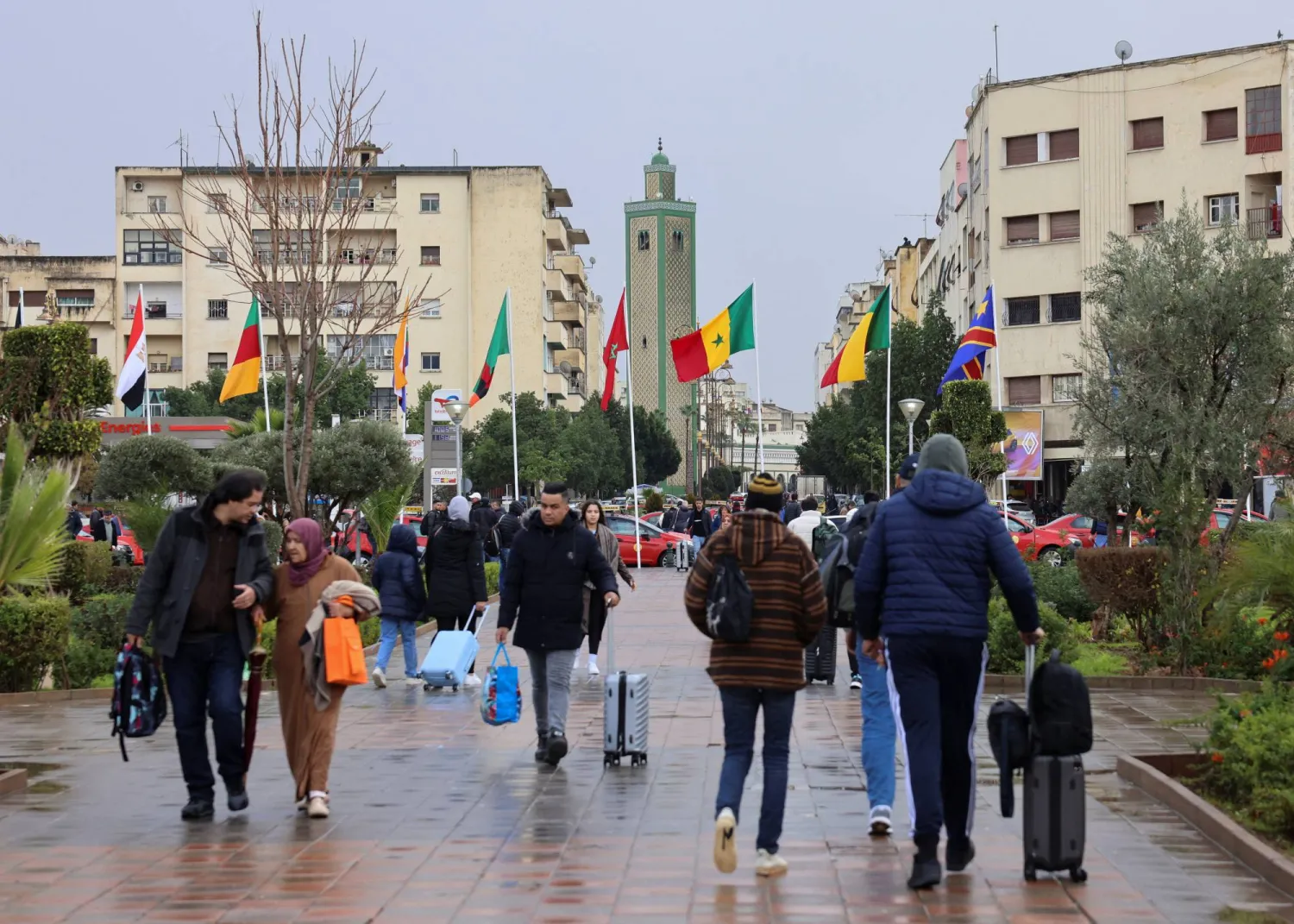 Passengers walk in front of Fes Railway Station, decorated with Africa Cup of Nations (AFCON) theme colors and flags, in the Moroccan city of Fes, January 5, 2026. (Reuters)