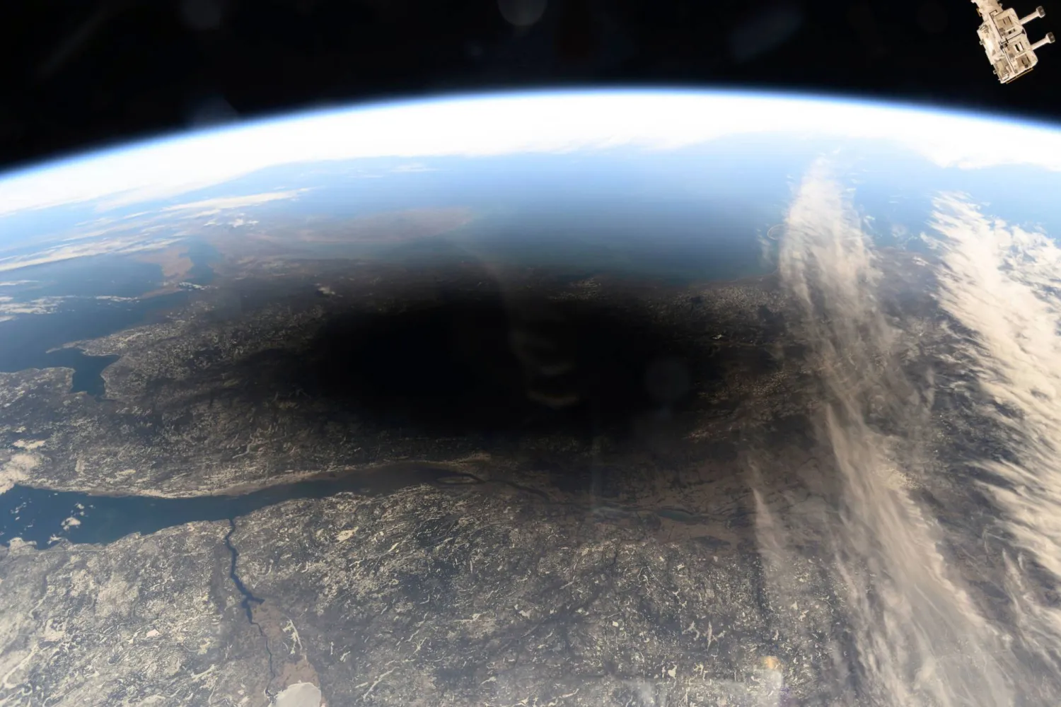 FILE - This photo provided by NASA shows the Moon's shadow covering portions of Canada and the US during a total solar eclipse as seen from the International Space Station on Monday, Aug. 8, 2024. (NASA via AP, File)