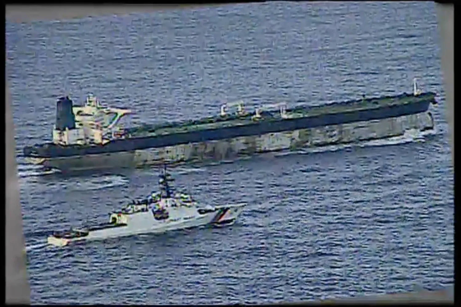This image from video provided by the US Department of Defense, shows the US Coast Guard cutter Munro shadowing the MV Bella 1 in the North Atlantic Ocean during the maritime interdiction operation Wednesday, Jan. 7, 2026. (Department of Defense via AP)