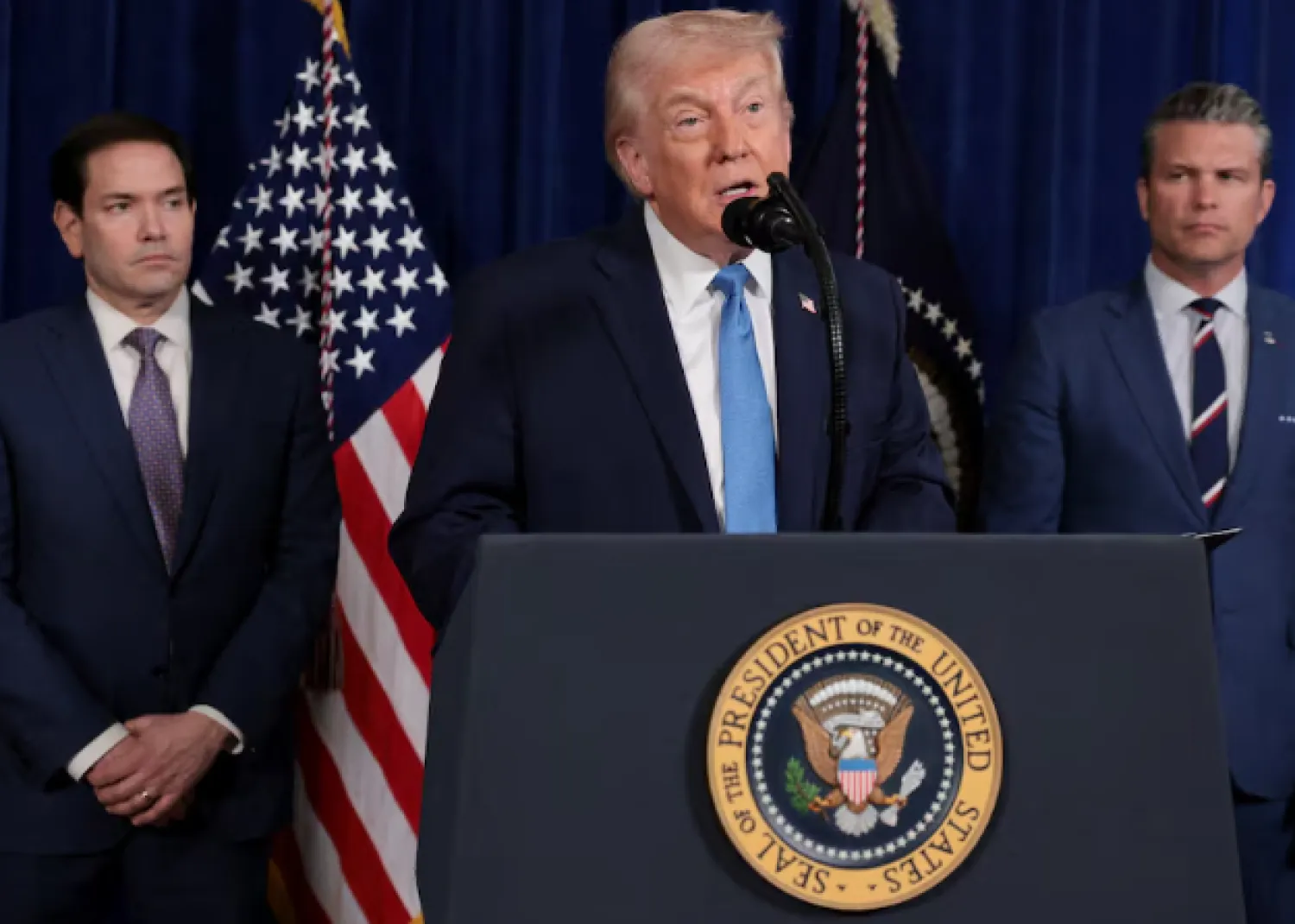 US President Donald Trump speaks as Secretary of State Marco Rubio and Secretary of Defense Pete Hegseth look on during a press conference following a US strike on Venezuela where President Nicolas Maduro and his wife, Cilia Flores, were captured, from Trump's Mar-a-Lago club in Palm Beach - Reuters