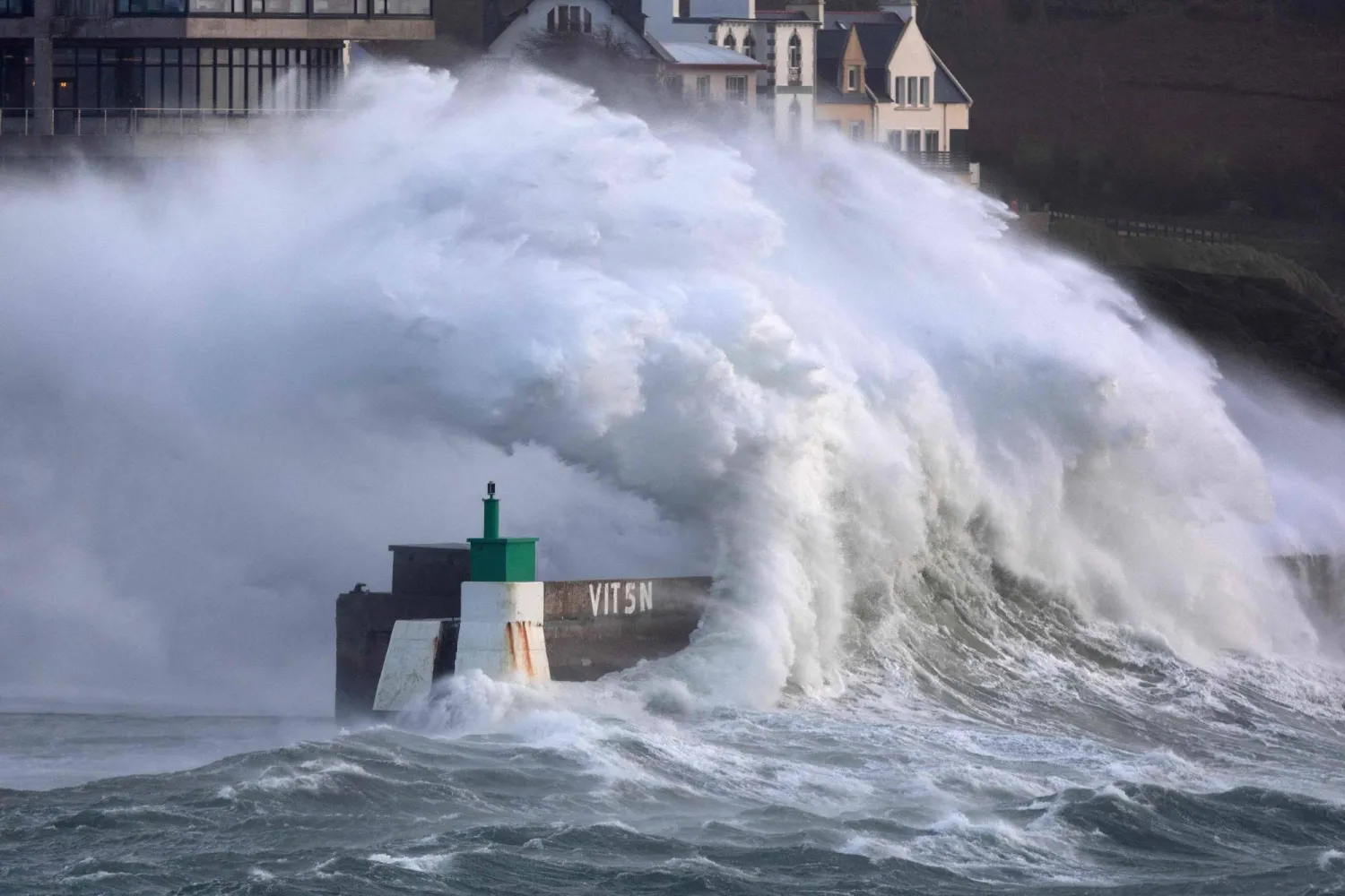 A huge wave crashes on the jetty of the harbor of Le Conquet, western France on January 8, 2026 as storm Goretti is announced to approach France's northern coasts. (Photo by Fred TANNEAU / AFP)
