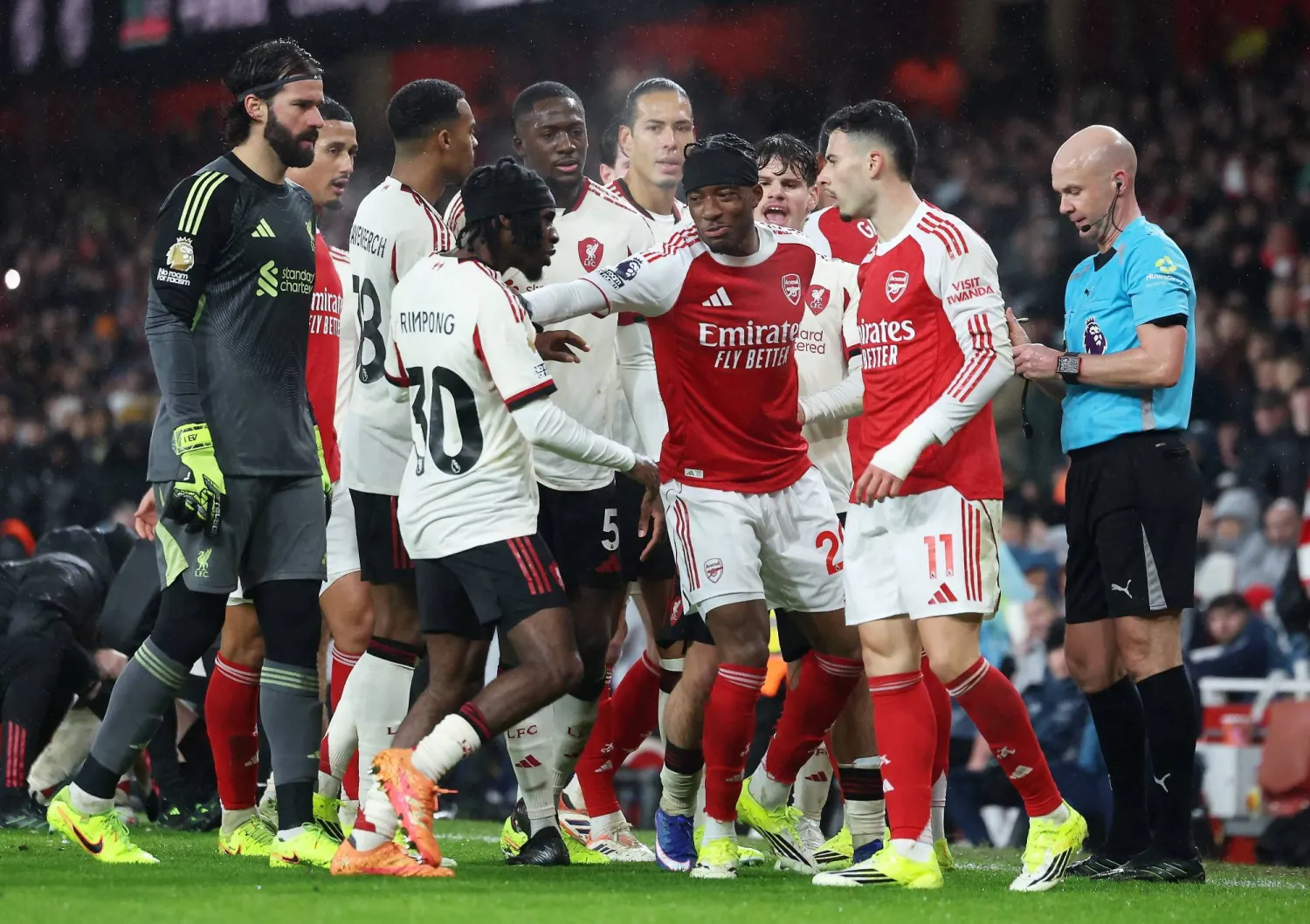 Noni Madueke (C) of Arsenal pushes back Jeremie Frimpong of Liverpool who is approaching Gabriel Martinelli (R) of Arsenal during the English Premier League match between Arsenal FC and Liverpool FC, in London, Britain, 08 January 2026. (EPA)