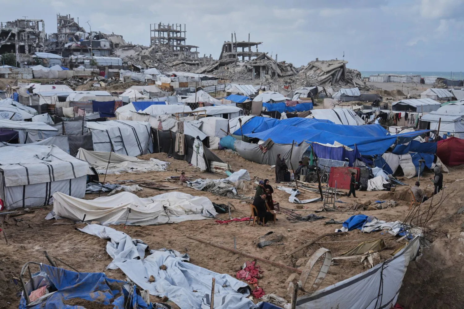  Palestinians inspect damaged tents at a displacement camp following an Israeli strike in Gaza City, Friday, Jan. 9, 2026. (AP) 