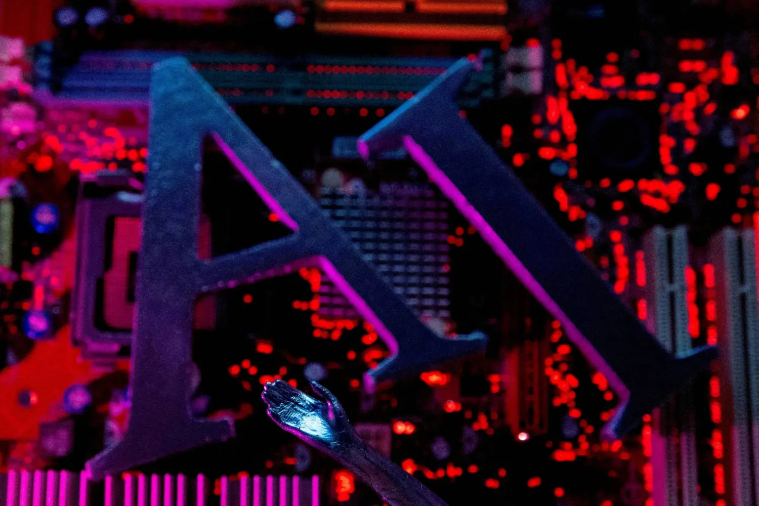 AI (Artificial Intelligence) letters and robot hand are placed on computer motherboard in this illustration created on June 23, 2023. (Reuters)