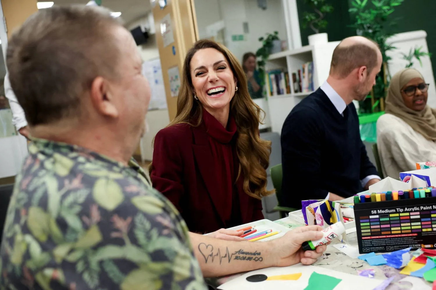 Britain's Catherine, Princess of Wales reacts as she speaks to a patient next to Prince William, Prince of Wales, during an arts workshop at Charing Cross Hospital, in London, Britain, January 8, 2026. (Reuters)