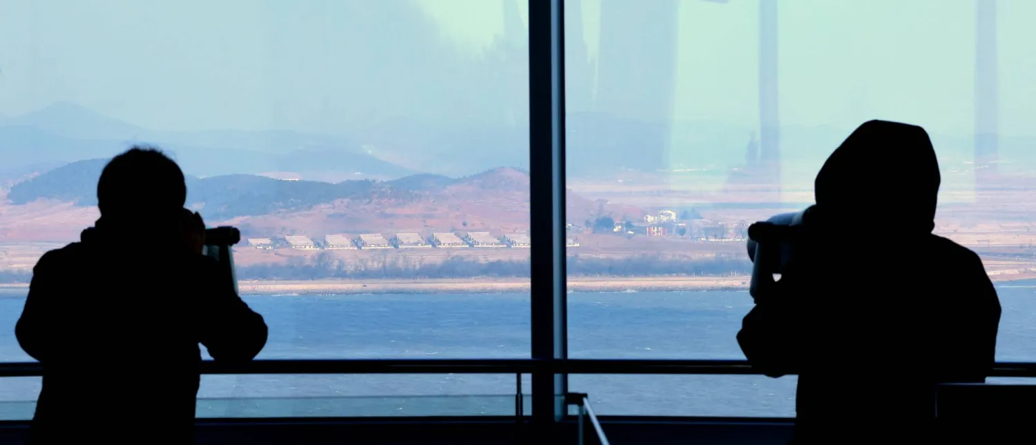 Visitors look at North Korea's border county of Kaepung through tower viewers at South Korea's Ganghwa Peace Observatory in the western county of Ganghwa; 10 January 2026. (EPA/Yonhap)