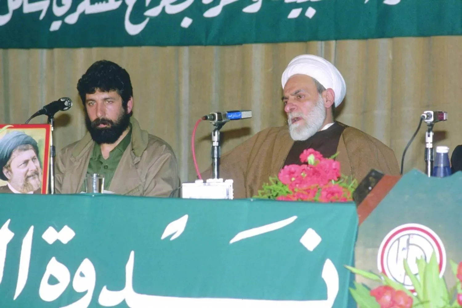 Sheikh Mohammad Mahdi Shamseddine during an event with Amal Movement military commander Akel Hamiyeh (Getty). 