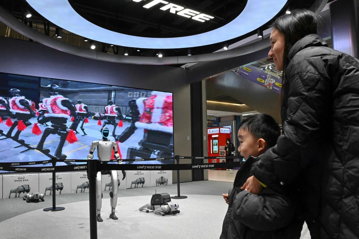  Visitors look at robots on display at robotics company Unitree's first retail store in Beijing in January 9, 2026. (AFP) 