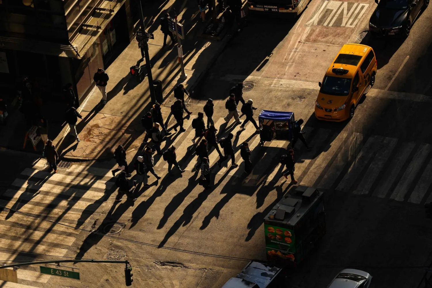 Pedestrians and cars move along Lexington Avenue in the Manhattan borough of New York City on December 16, 2025. (Photo by CHARLY TRIBALLEAU / AFP)