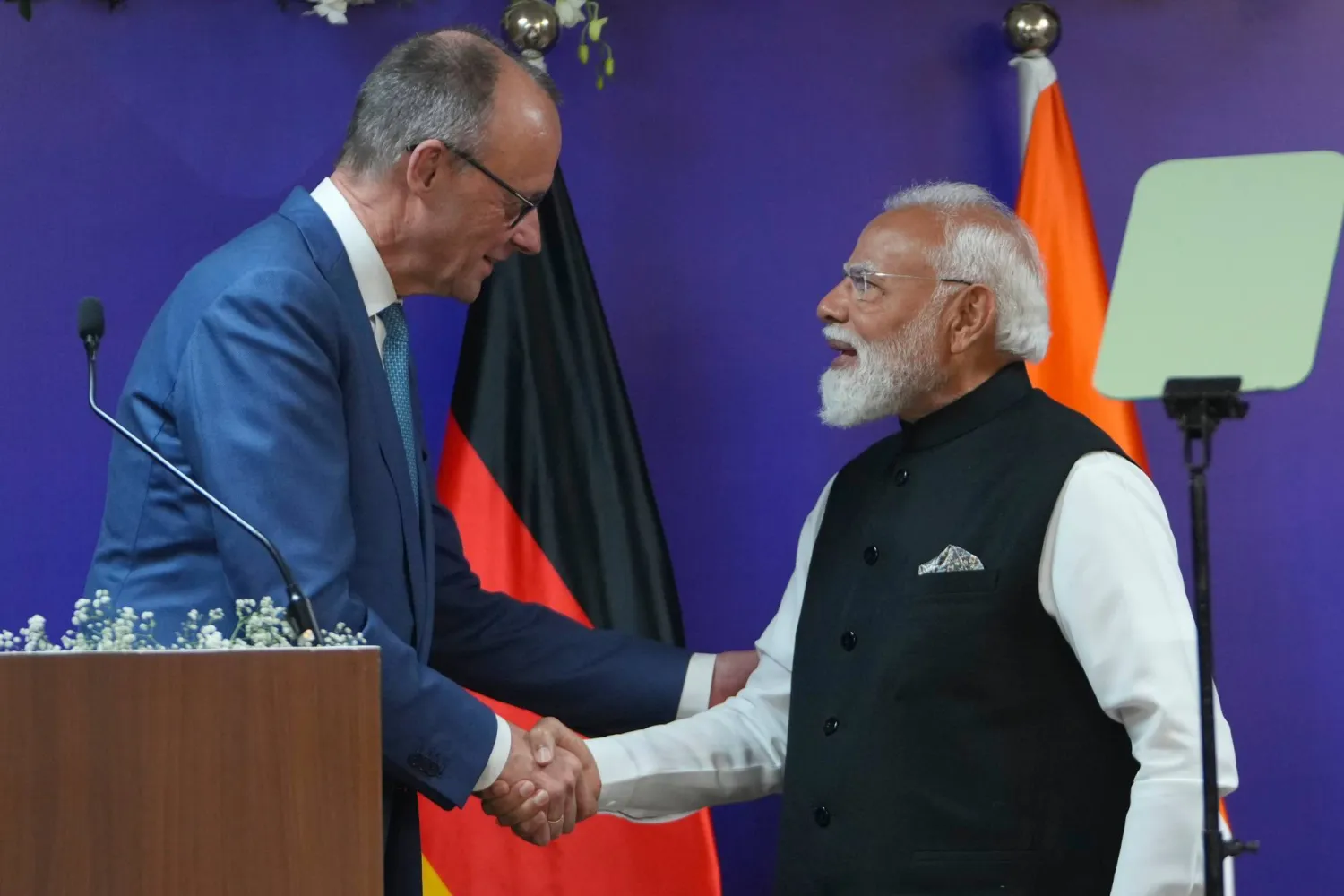 German Chancellor Friedrich Merz, left, shakes hands with Indian Prime Minister Narendra Modi following a joint statement to the media in Gandhinagar, India, Monday, Jan. 12, 2026. (AP)