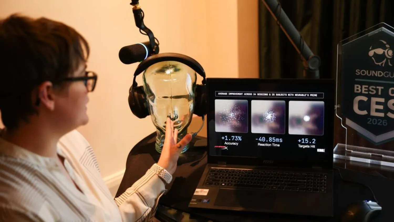 Neurable research scientist Alicia Howell-Munson demonstrates the company's headset, which it says can detect early signs of Alzheimer's disease. Patrick T. Fallon / AFP
